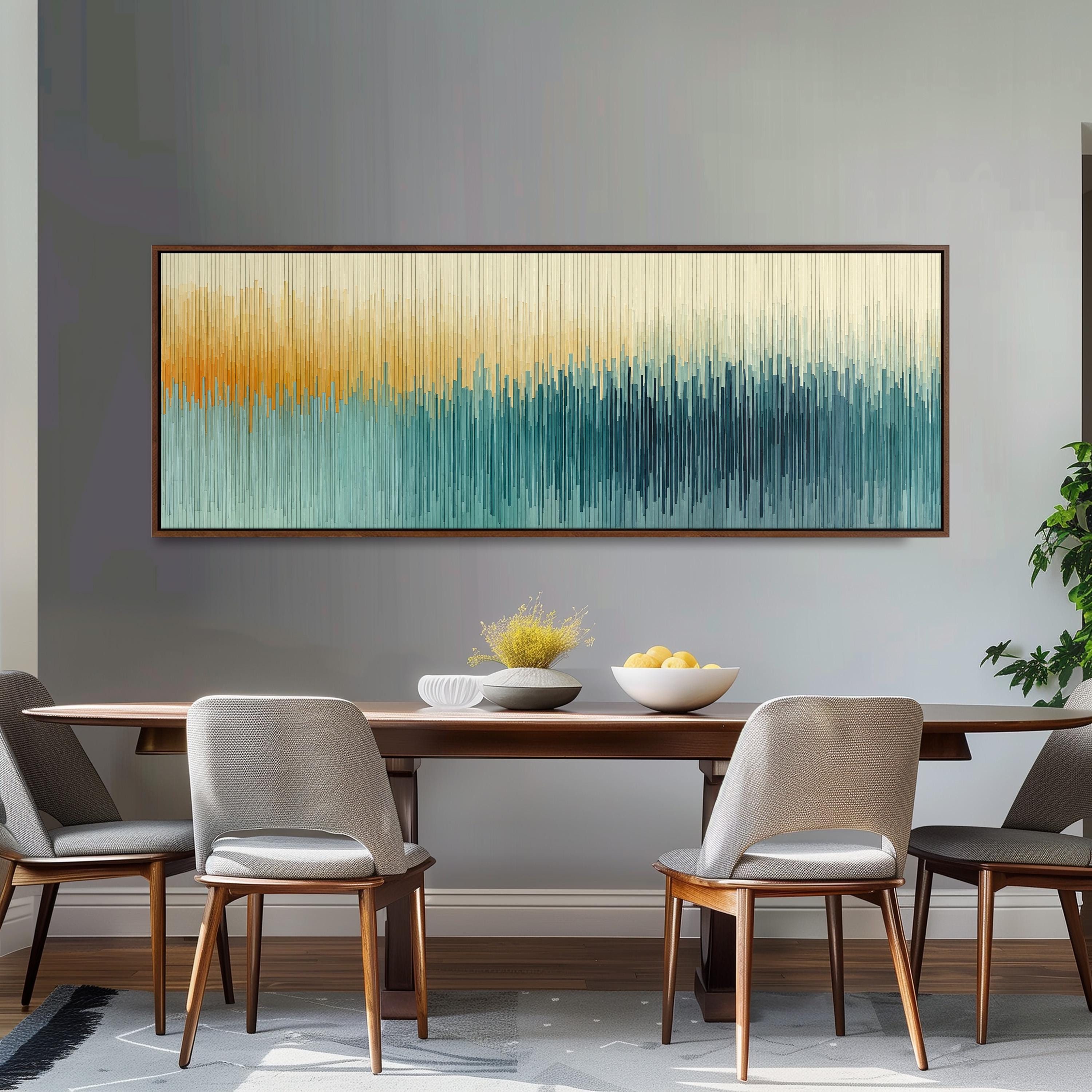 a modern dining room with a wooden table and four gray chairs. Above the table, there is a large abstract painting with a gradient of colors, creating a vibrant and dynamic atmosphere. The painting is framed and hangs on the wall, serving as a focal point in the room.
