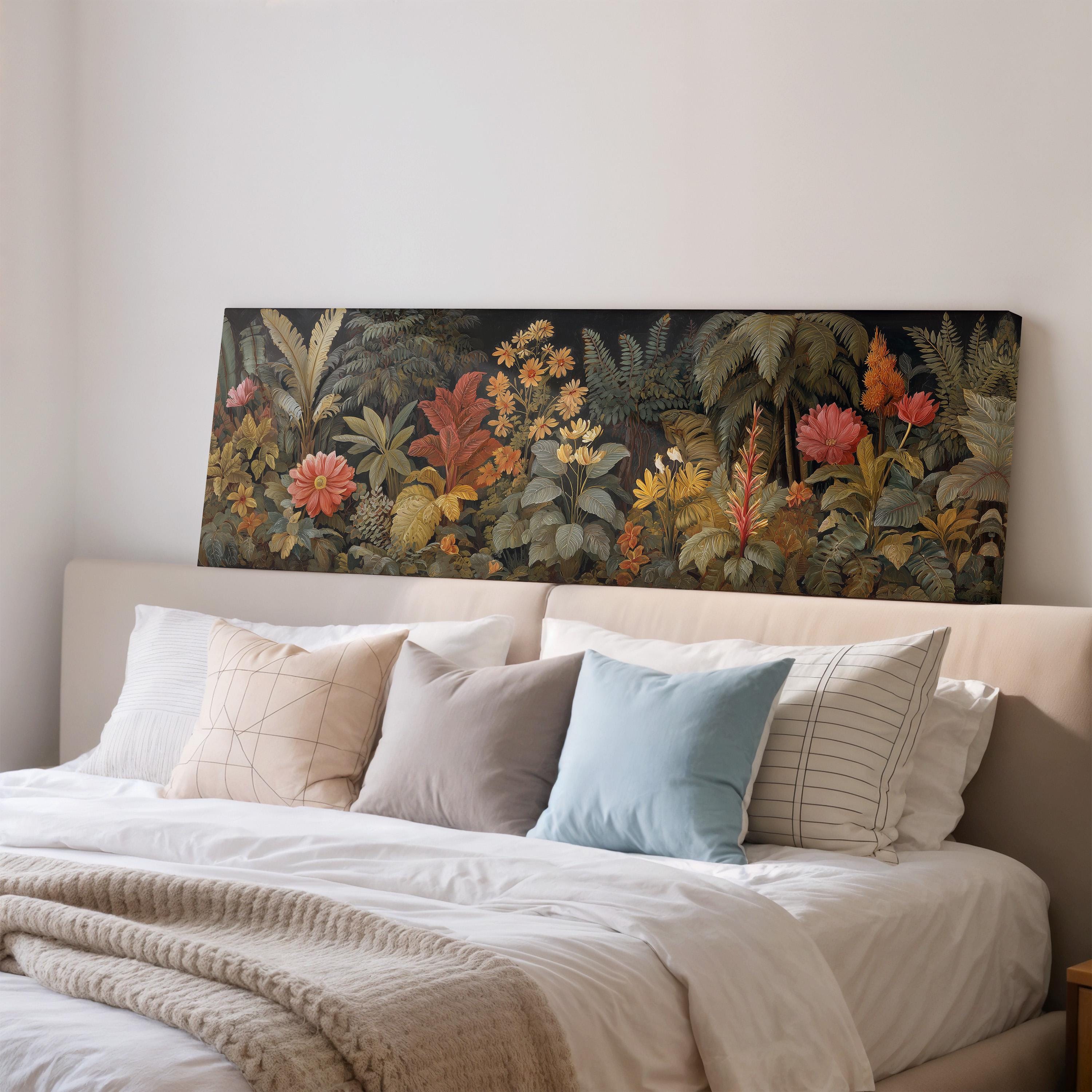 a large, colorful painting of a tropical garden hanging above a bed with white pillows and a gray blanket.