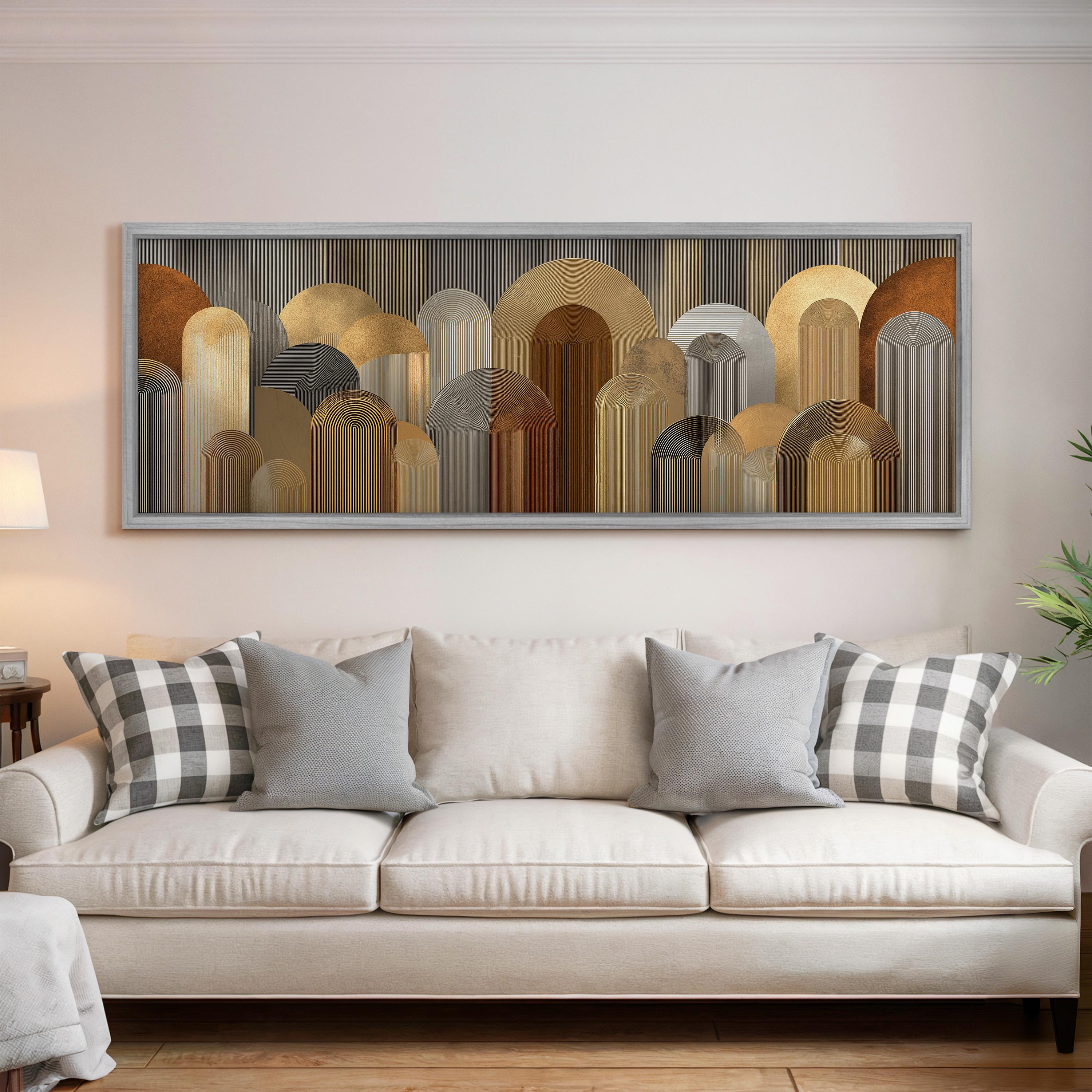 a large, abstract painting hanging on a wall above a white couch with gray and white plaid throw pillows.