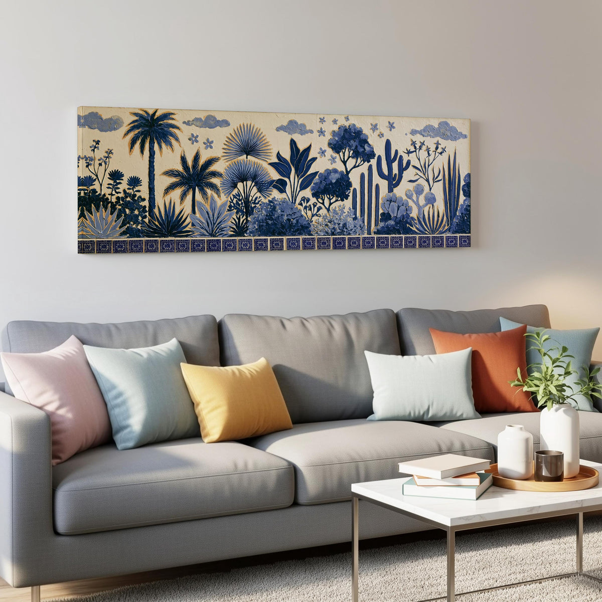 Blue palms, cacti and flowers pattern panoramic canvas print above a grey sofa in a living room