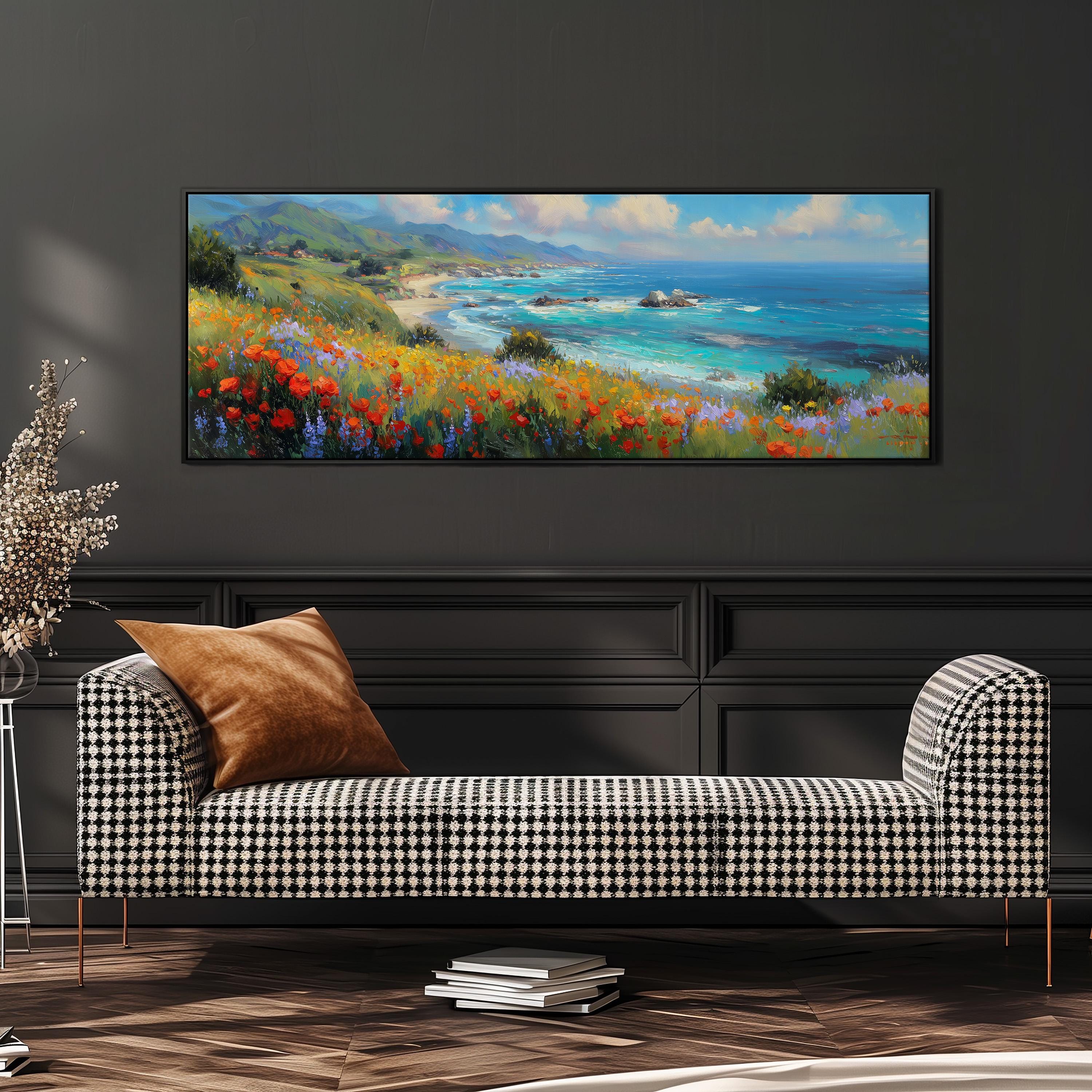 a large, colorful painting of a coastal landscape hanging on a wall above a black and white checkered sofa.