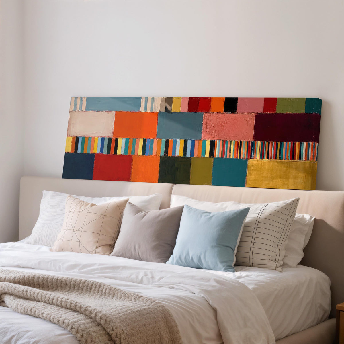 Rainbow patchwork color bands wide panoramic canvas print above a bed in a bedroom