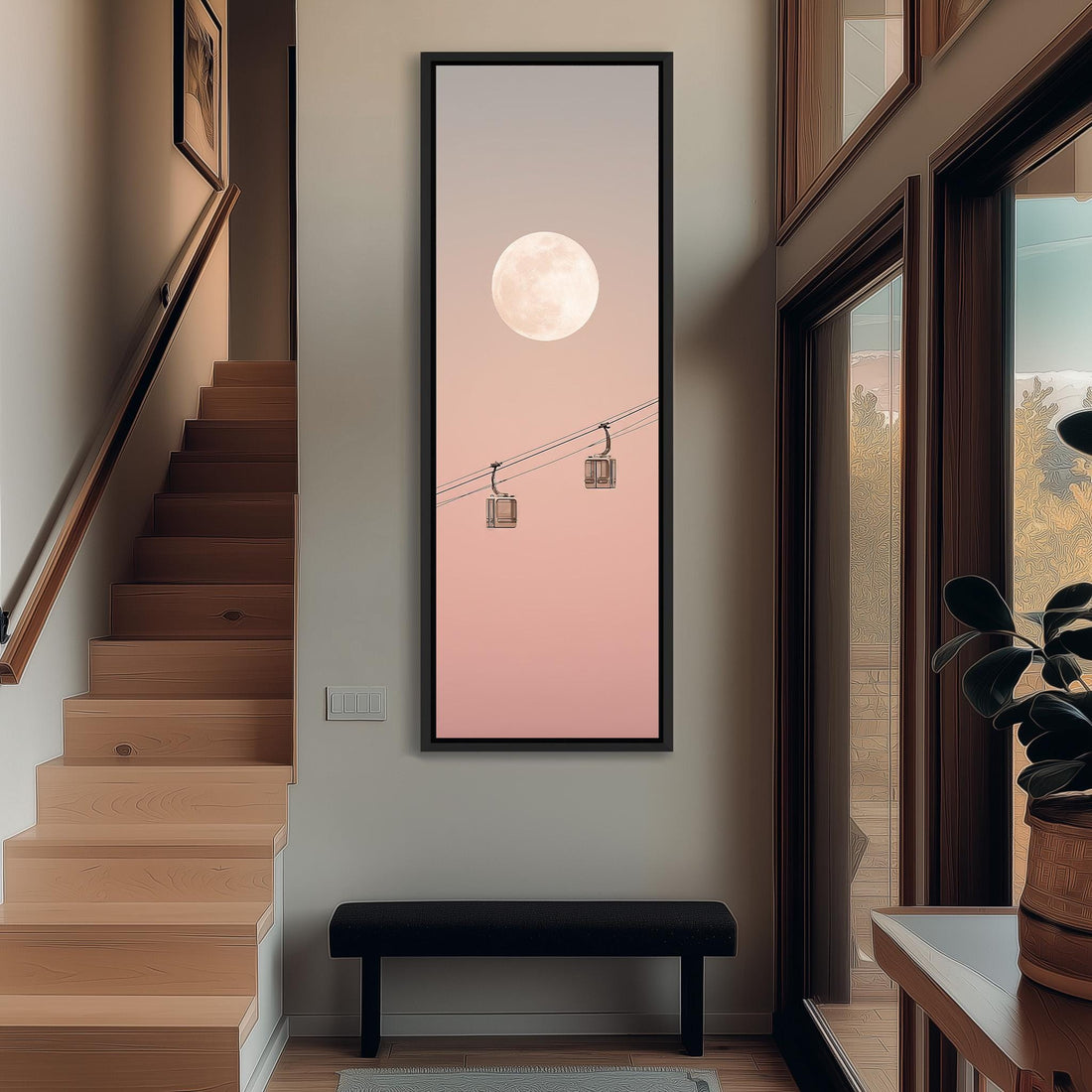 a large framed artwork hanging on a wall, depicting a serene scene with a full moon and two hanging lanterns.