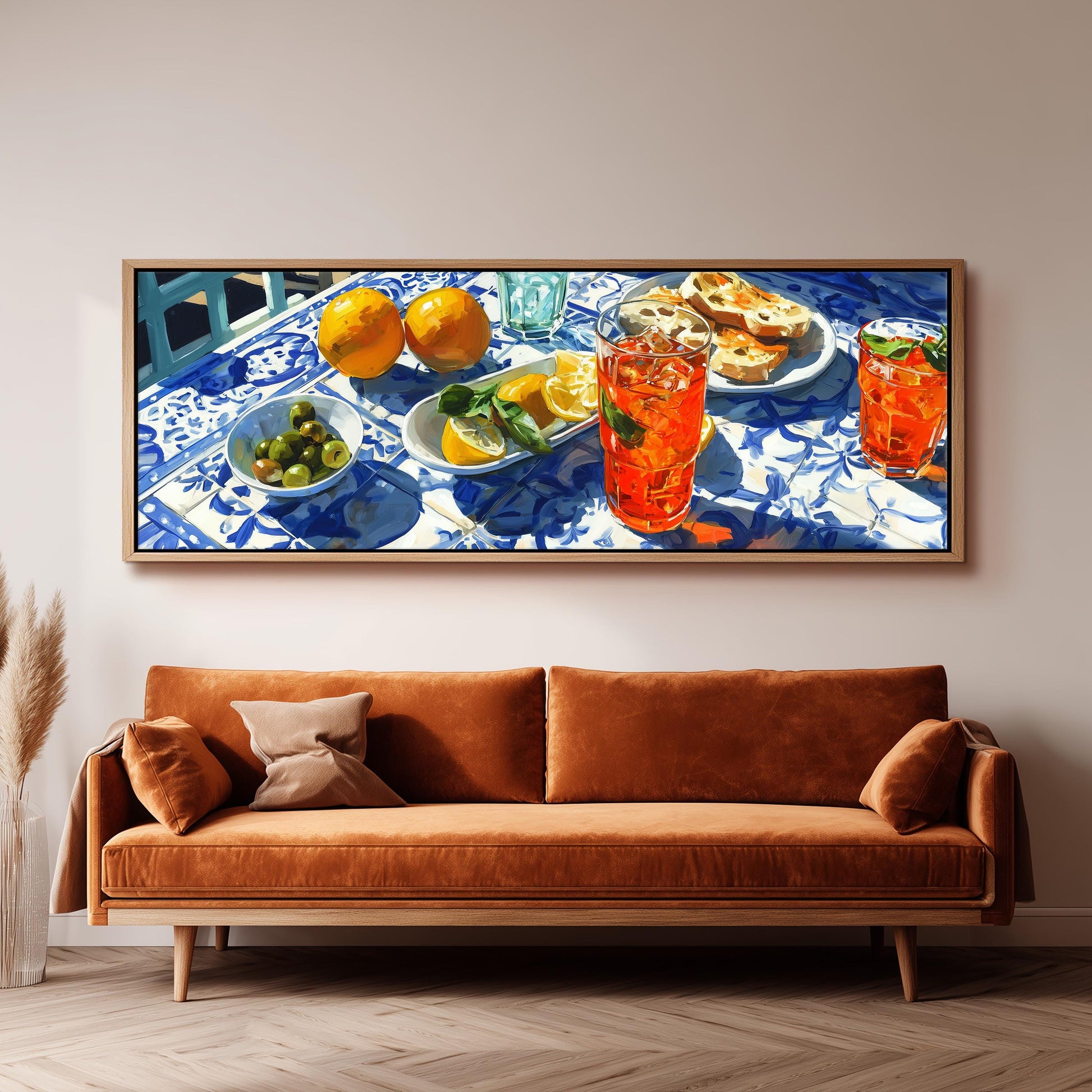 a table set with various food items and drinks, including oranges, a bowl of olives, and glasses filled with orange-colored beverages.