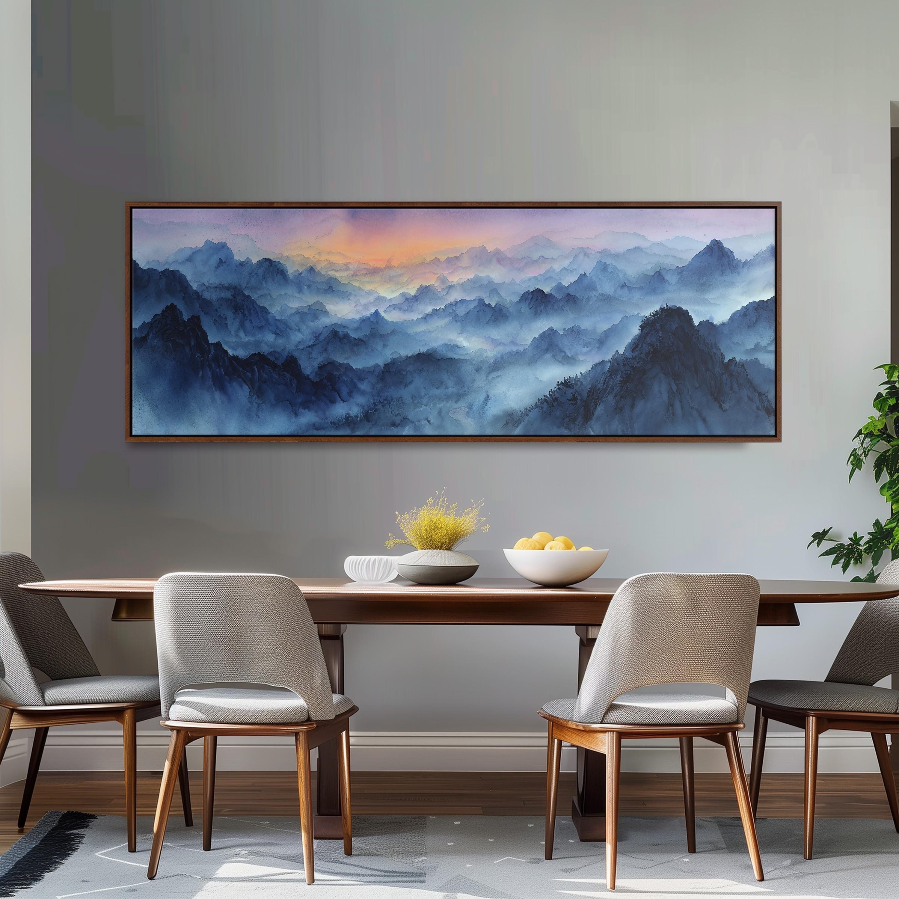 a dining room with a large painting of a mountainous landscape hanging on the wall above a wooden dining table with four chairs. The table is set with a bowl of fruit and a vase of flowers, creating a cozy and inviting atmosphere.