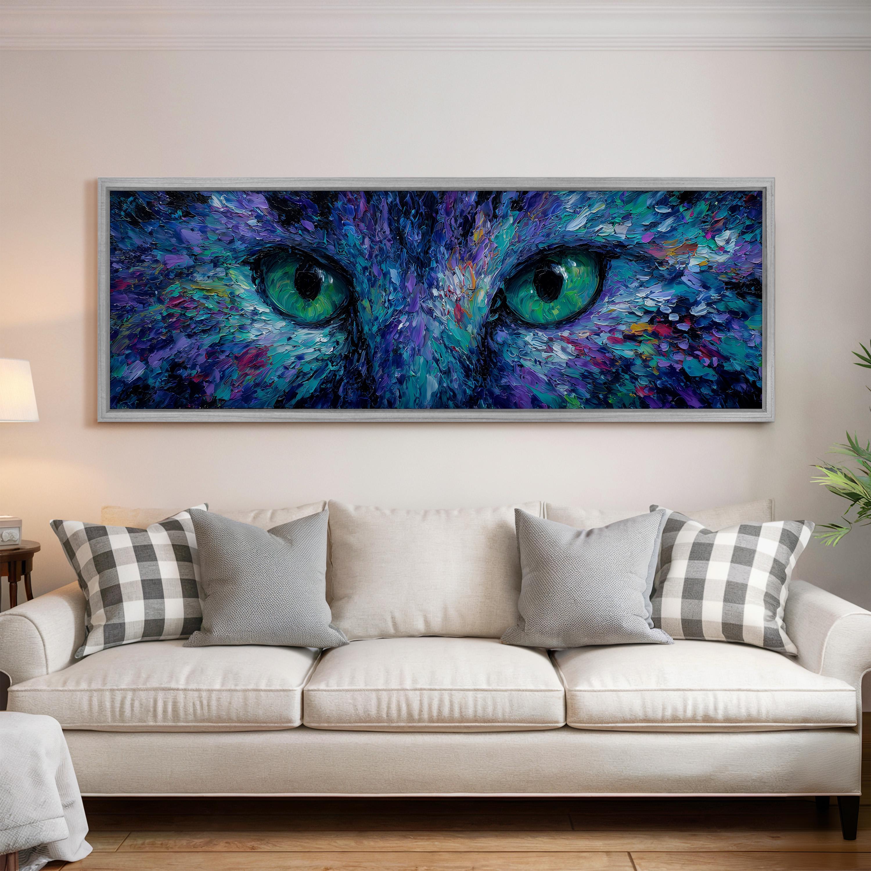 a large, colorful painting of a cat's eyes hanging on a wall above a white couch in a living room.