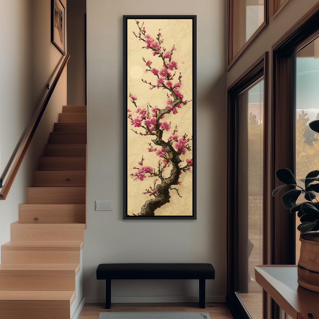 a large framed painting of a cherry blossom tree with pink flowers hanging on a wall.