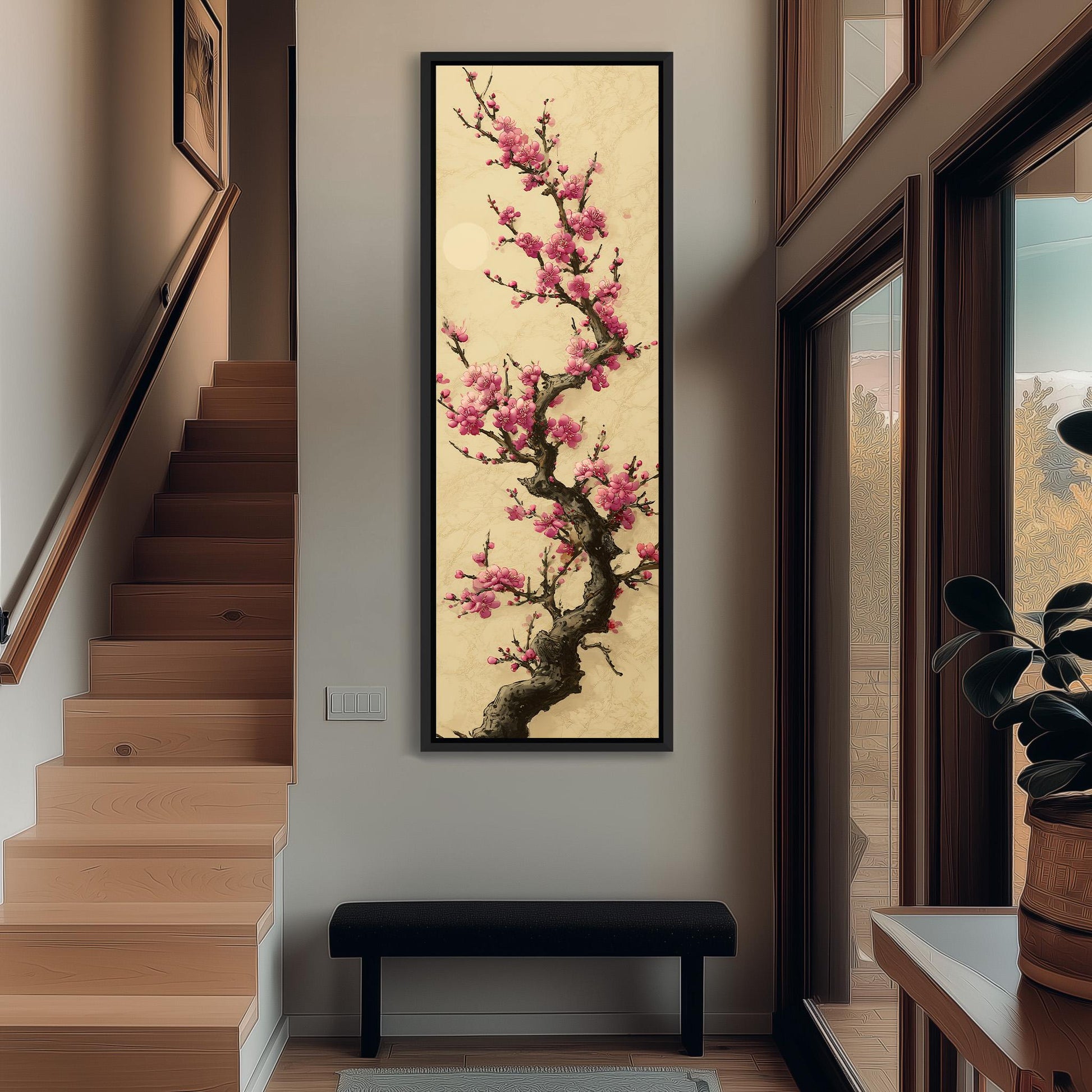 a large, framed painting of a cherry blossom tree with pink flowers hanging on the wall of a hallway. The painting is the focal point of the space, with a wooden staircase visible in the background.