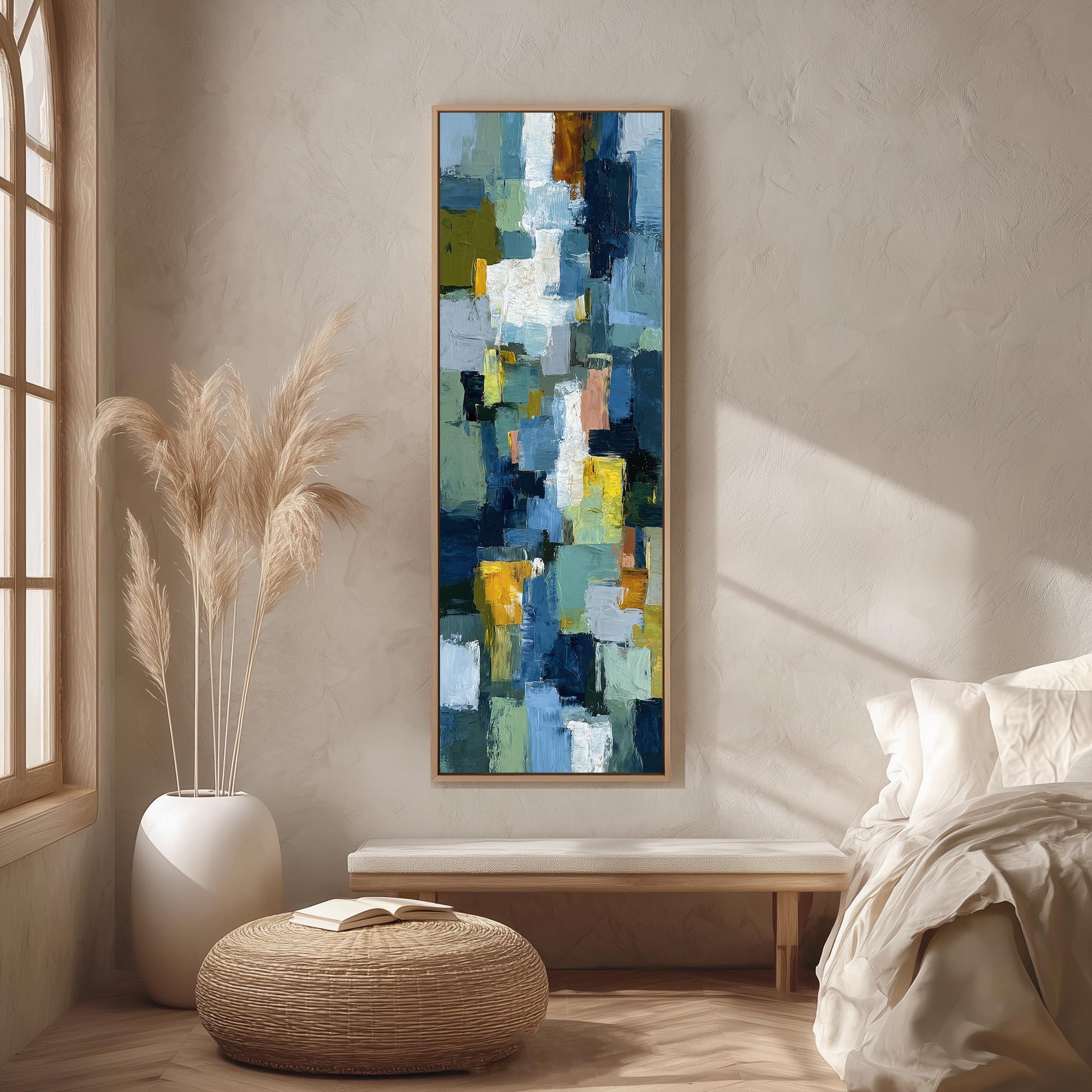 a large abstract painting hanging on a wall in a room with a bed, a wicker ottoman, and a potted plant.