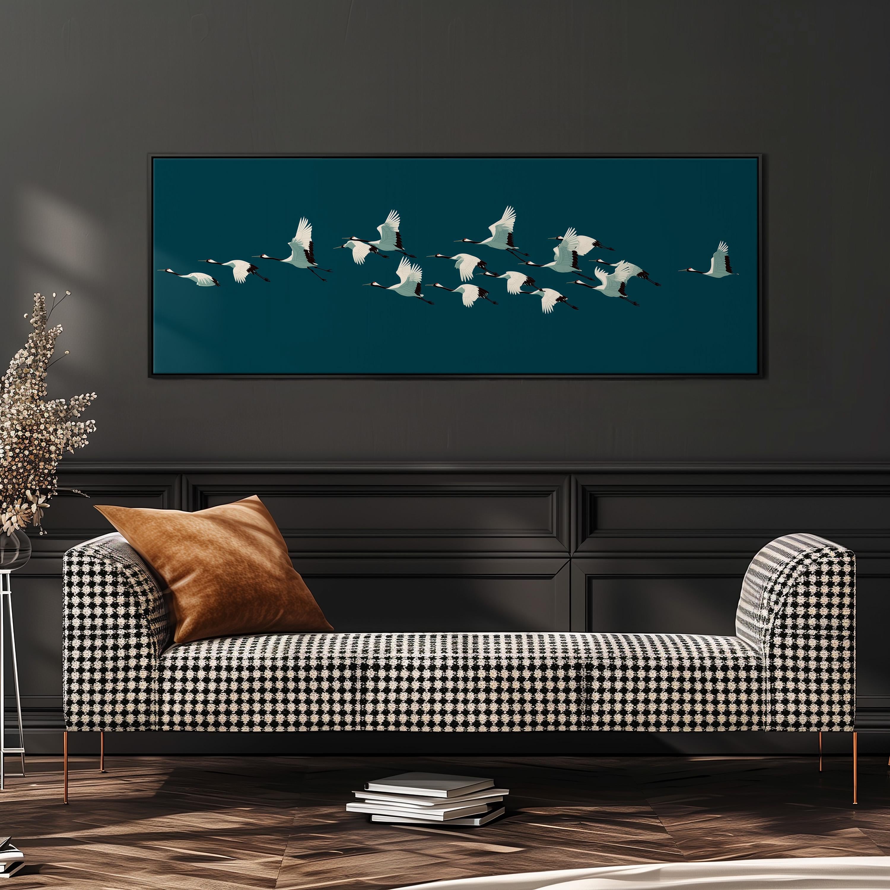 a black and white checkered sofa with a brown throw pillow, set against a dark wall with a framed image of a flock of white birds flying across it.