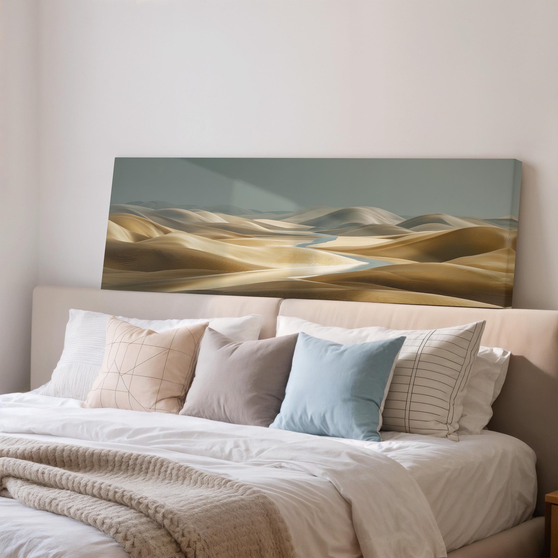 a large bed with a white comforter and pillows, and a painting of a desert landscape above it.