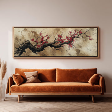 a large, framed painting of a tree branch with red flowers hanging above a brown sofa in a living room setting.