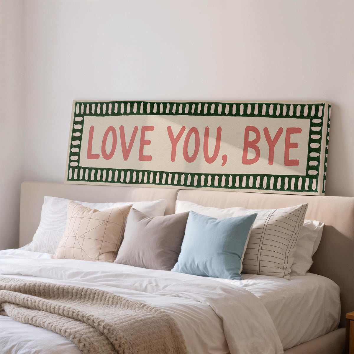 Love you, bye sign with a green border wide panoramic canvas print above a bed in a bedroom