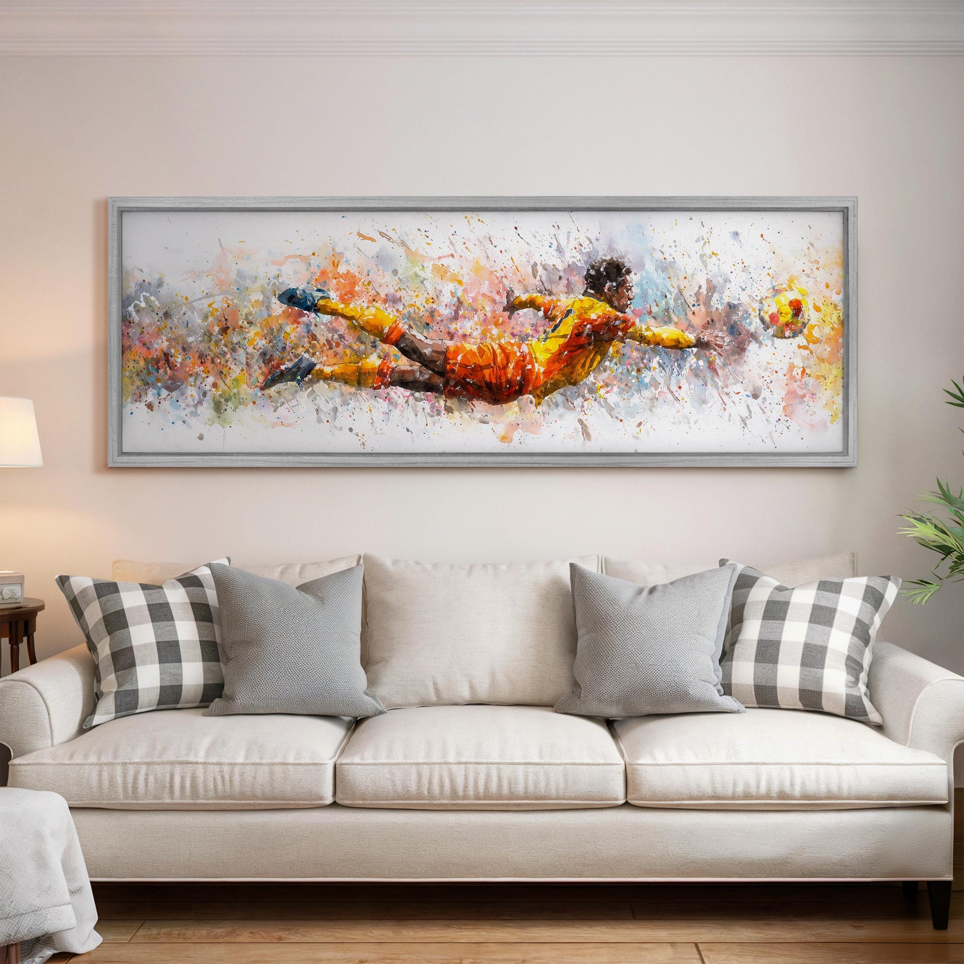 a large, colorful painting of a soccer player in mid-air, with splashes of color and dynamic brushstrokes, hanging on a wall above a white couch with patterned throw pillows.