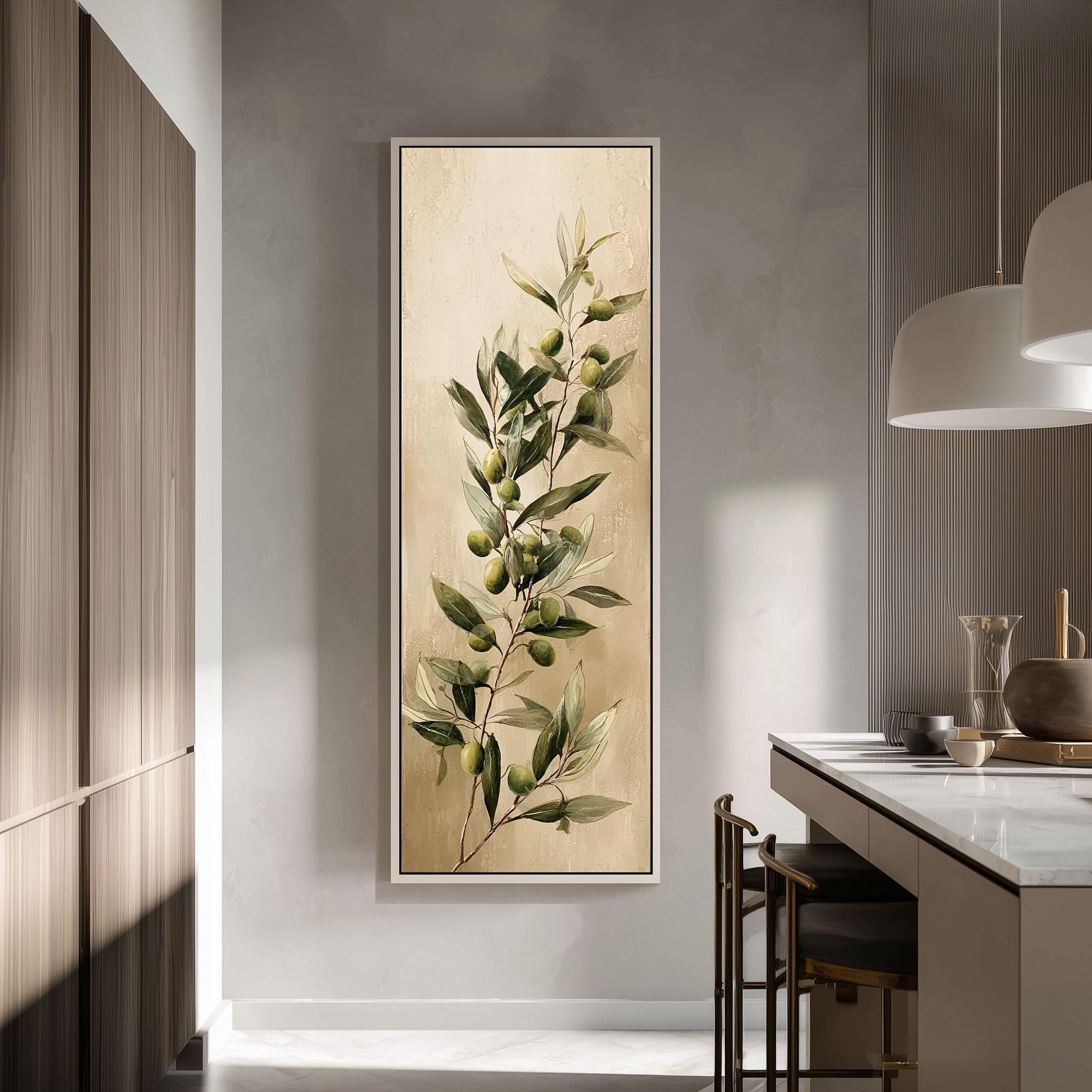 a large framed painting of a branch with green leaves and small green fruits hanging on a wall in a modern kitchen.
