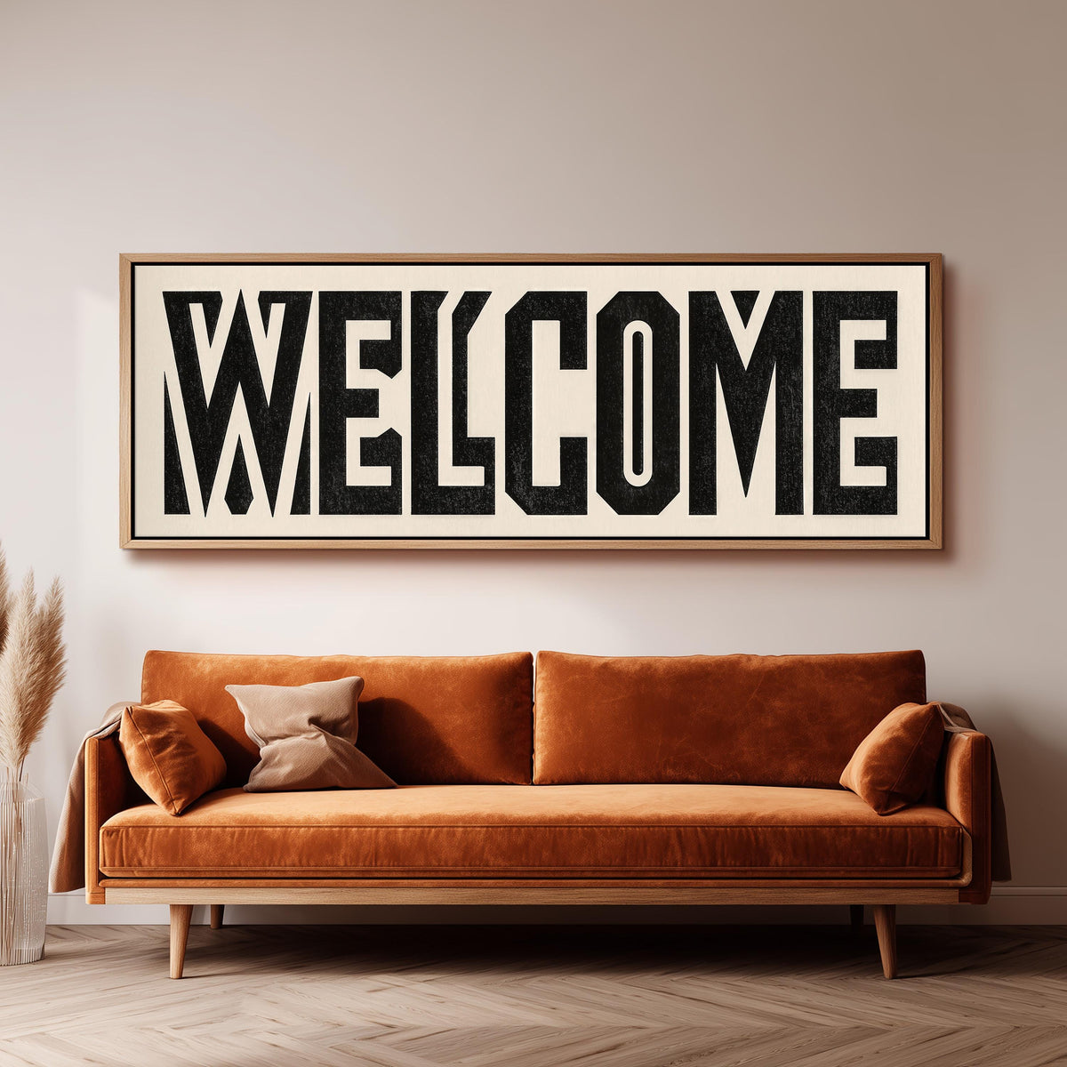 Bold welcome block letters wide panoramic canvas print above a bench in a dark living room