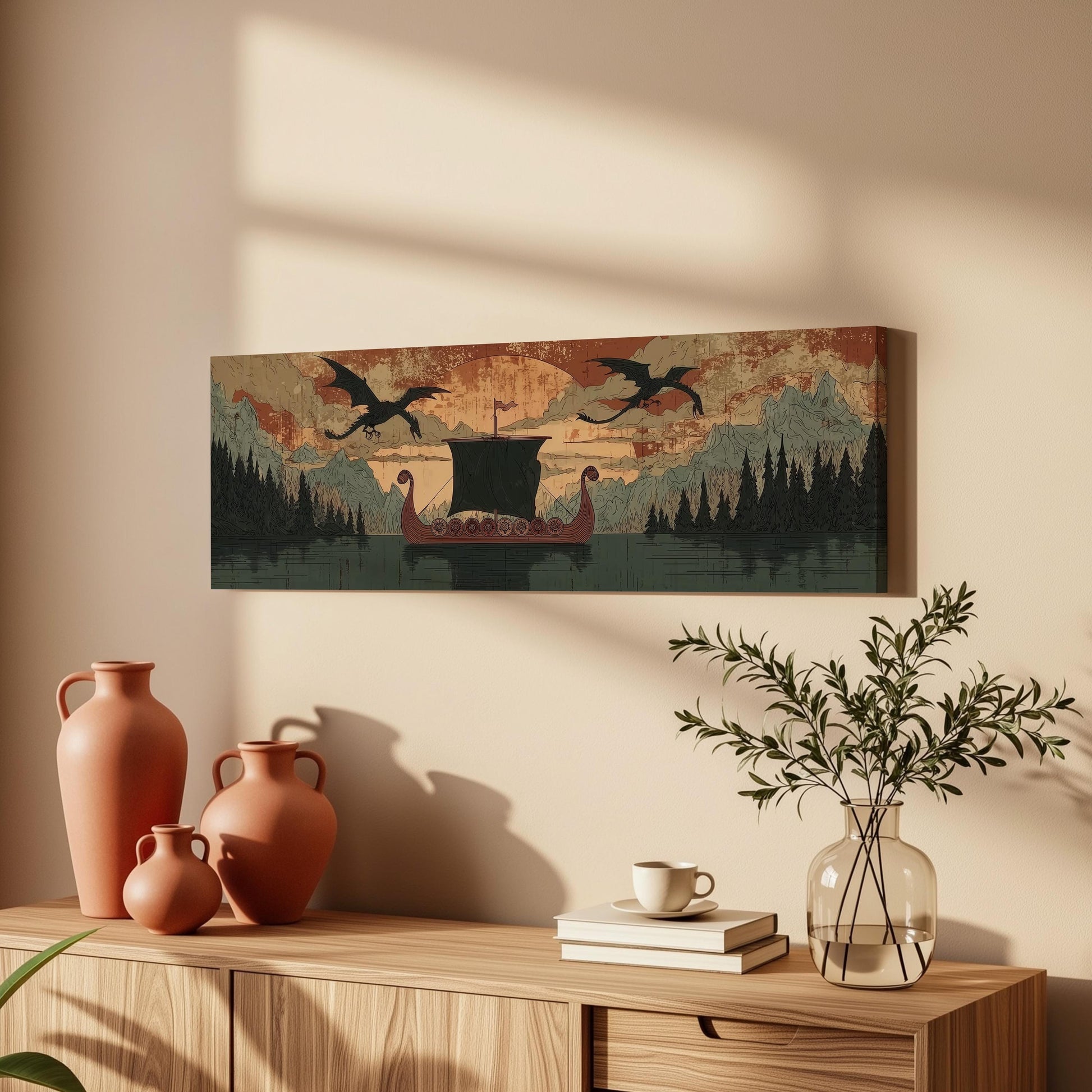 a wooden cabinet with a vase, a stack of books, and a potted plant. Above the cabinet, there is a framed artwork depicting a dragon boat on a lake, with mountains in the background.