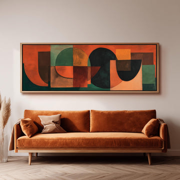 a large abstract painting hanging on a wall above a brown sofa with two pillows.