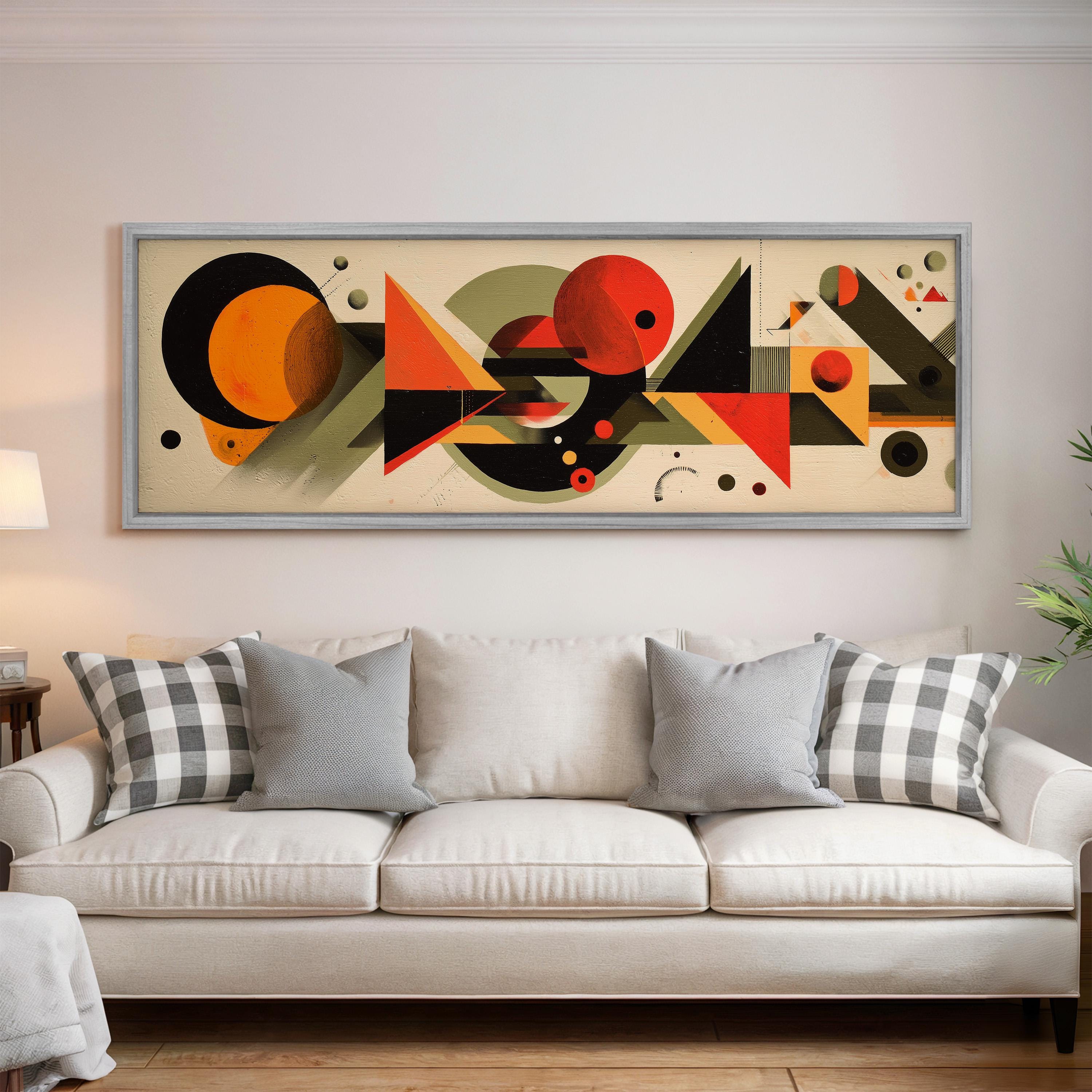 a large abstract painting hanging on a wall above a white couch with gray and white plaid throw pillows.
