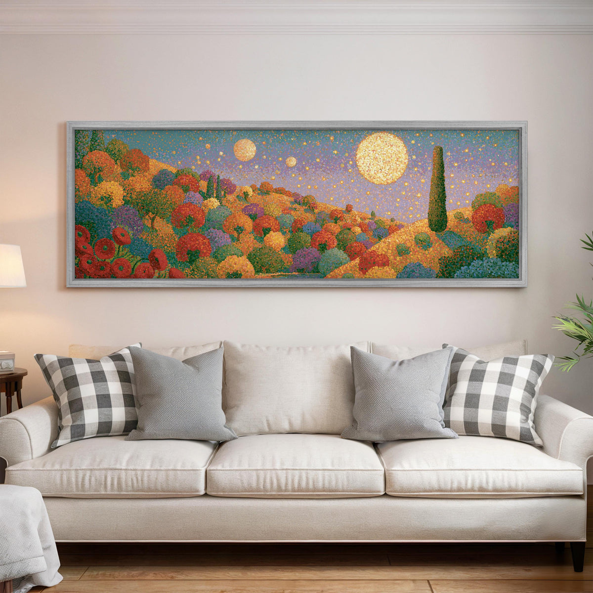 Autumn hillside under glowing moons panoramic canvas print above a white sofa in a bright living room