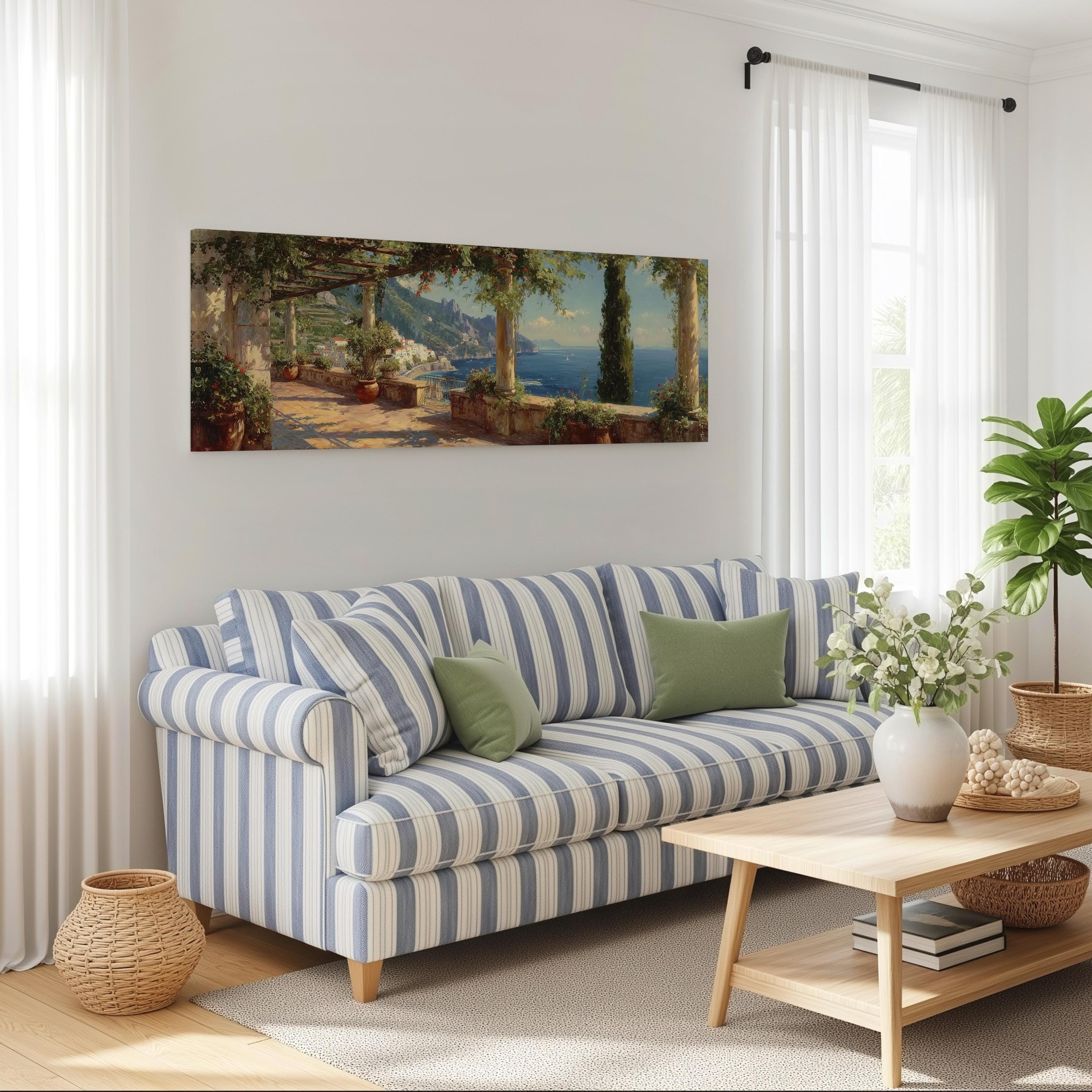 a cozy living room with a striped blue and white sofa, a wooden coffee table, and a large painting of a coastal landscape hanging on the wall.
