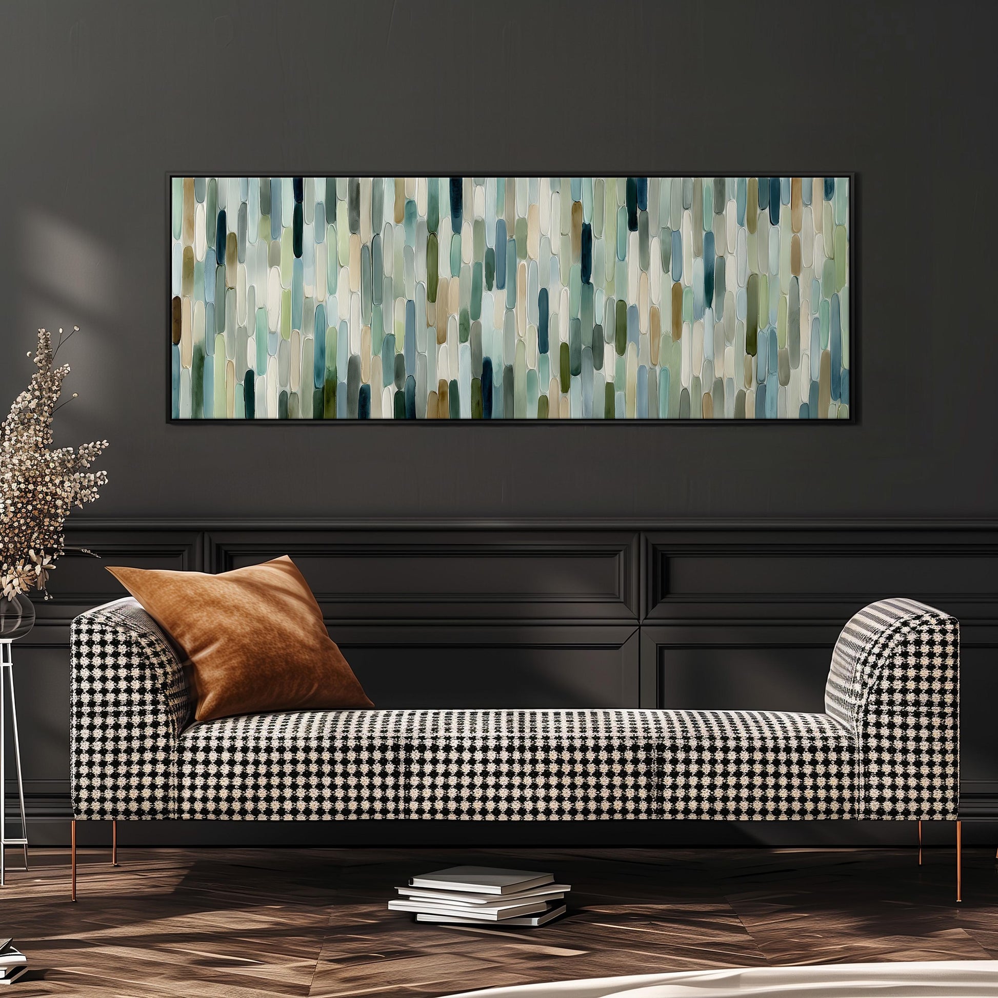a modern living room with a black and white checkered sofa, a large abstract painting on the wall, and a stack of books on the floor.