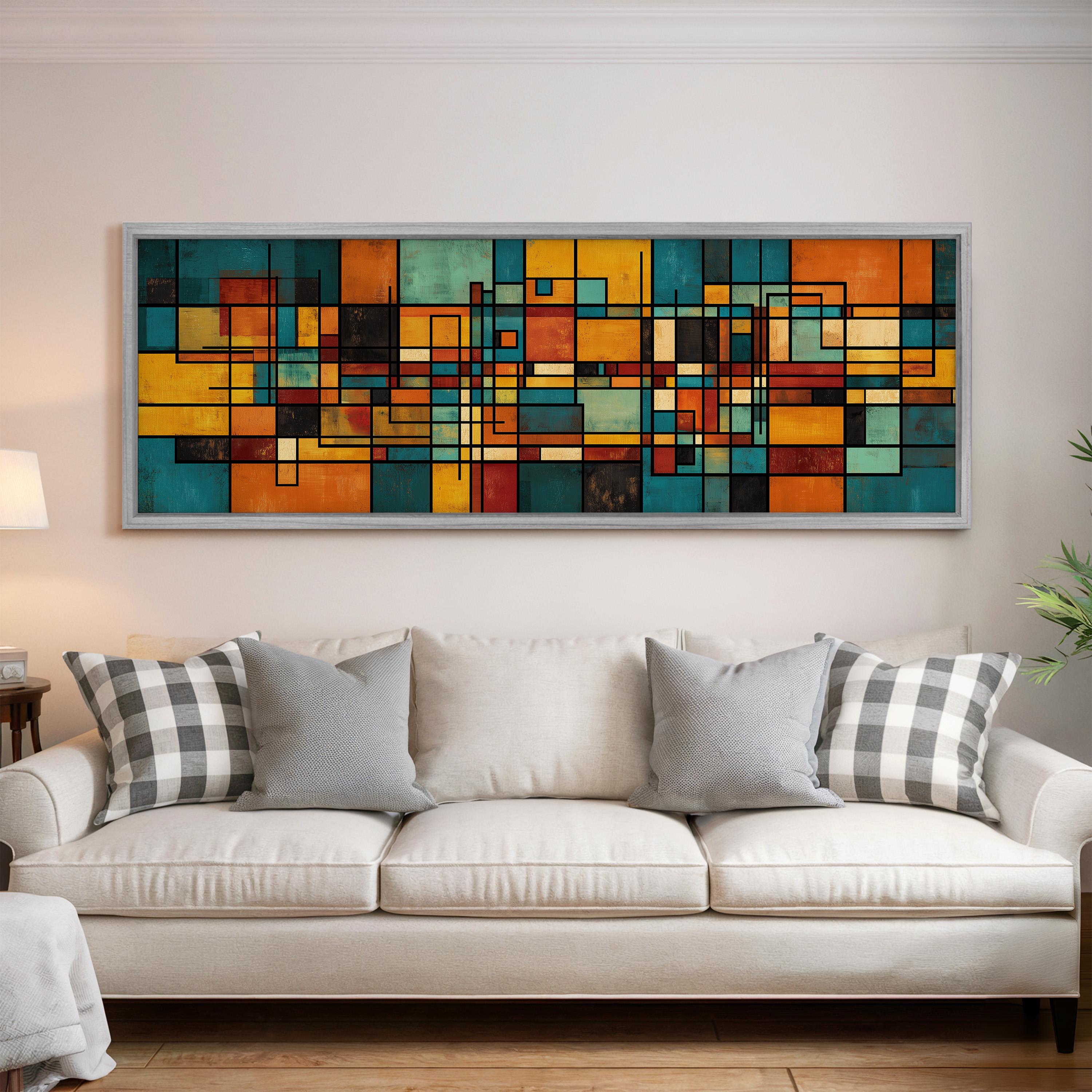 a large, colorful abstract painting hanging on a wall above a white couch with gray and white patterned pillows.