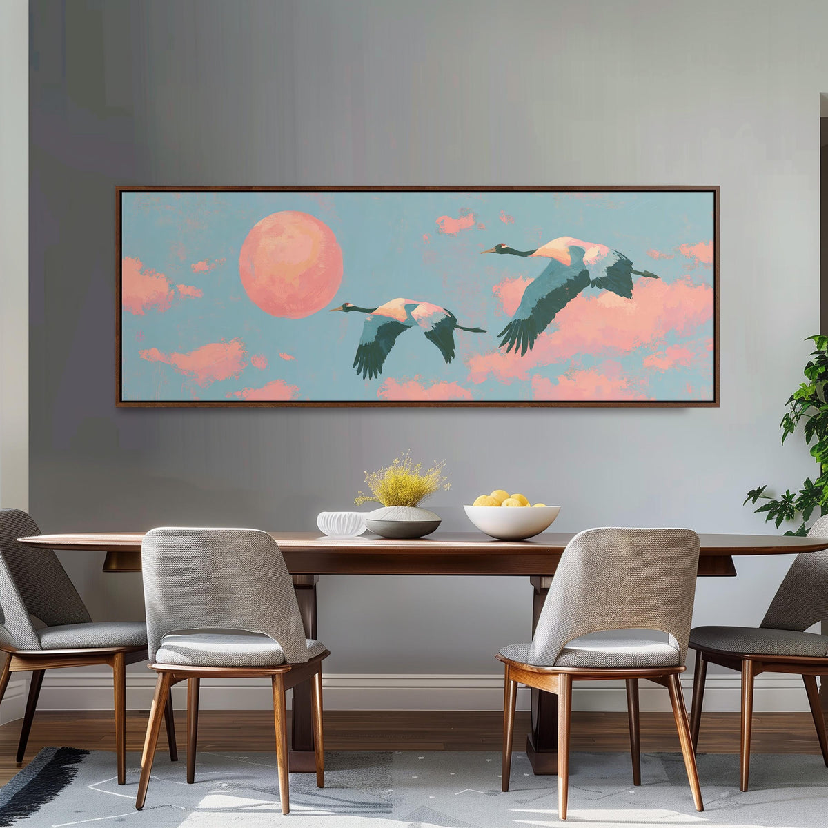 Two cranes flying at sunset long horizontal canvas print above a dining table