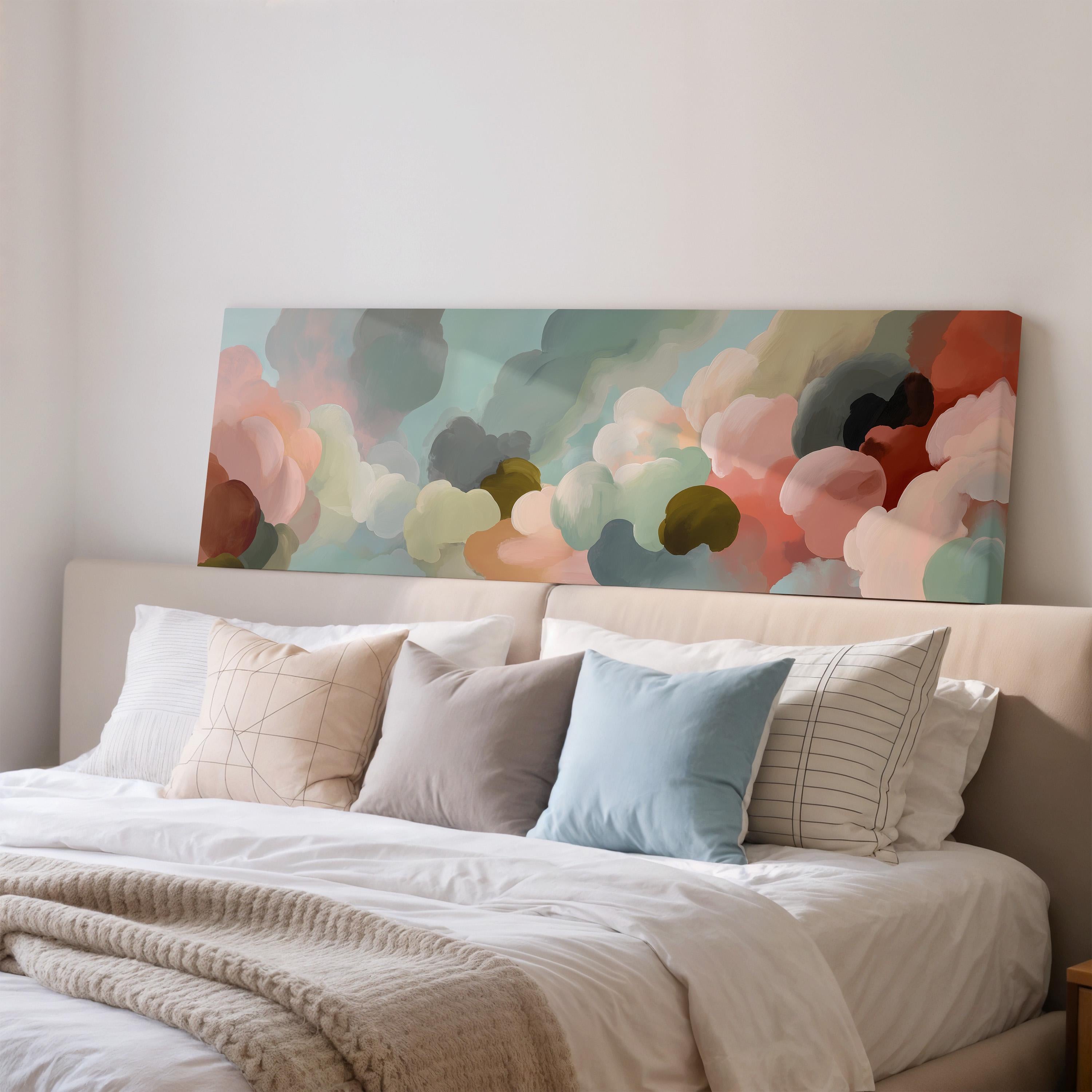 a large bed with a white comforter and a colorful abstract painting hanging above it.