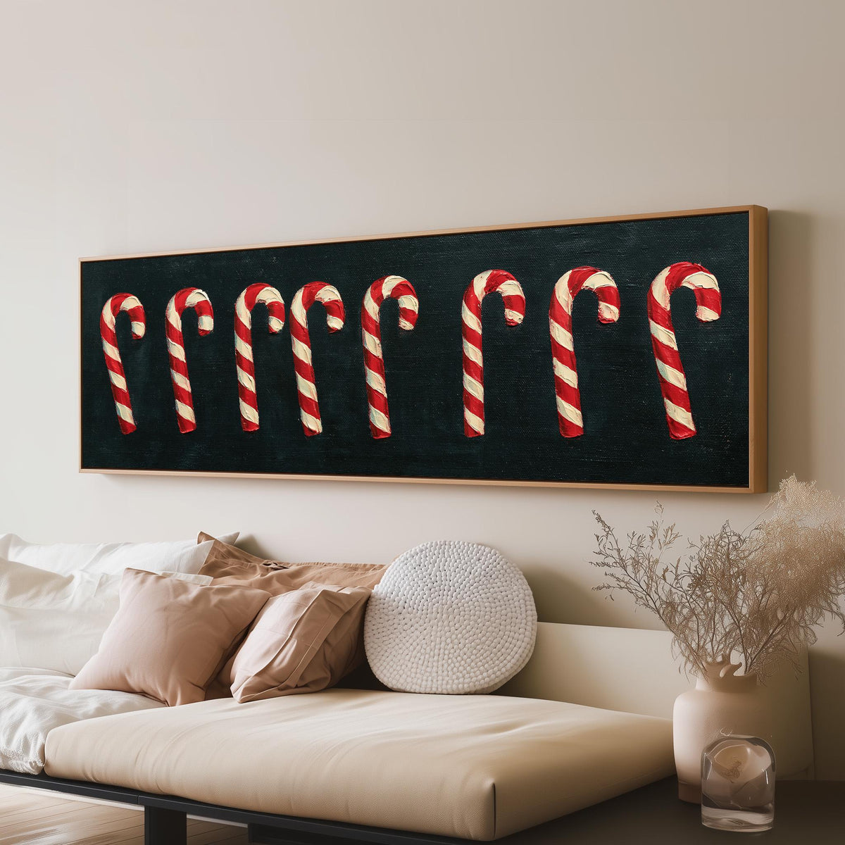 Row of candy canes on black panoramic canvas print above a sofa in a living room
