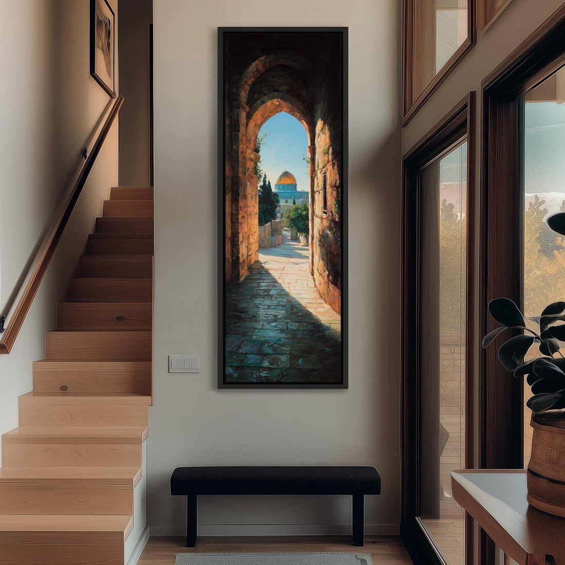 a large painting of a stone archway leading to a building with a dome, hanging on a wall in a room with a wooden floor and a window.