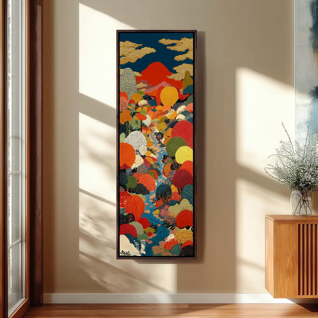 a large, colorful painting hanging on a wall in a room with a wooden chair and a small table.