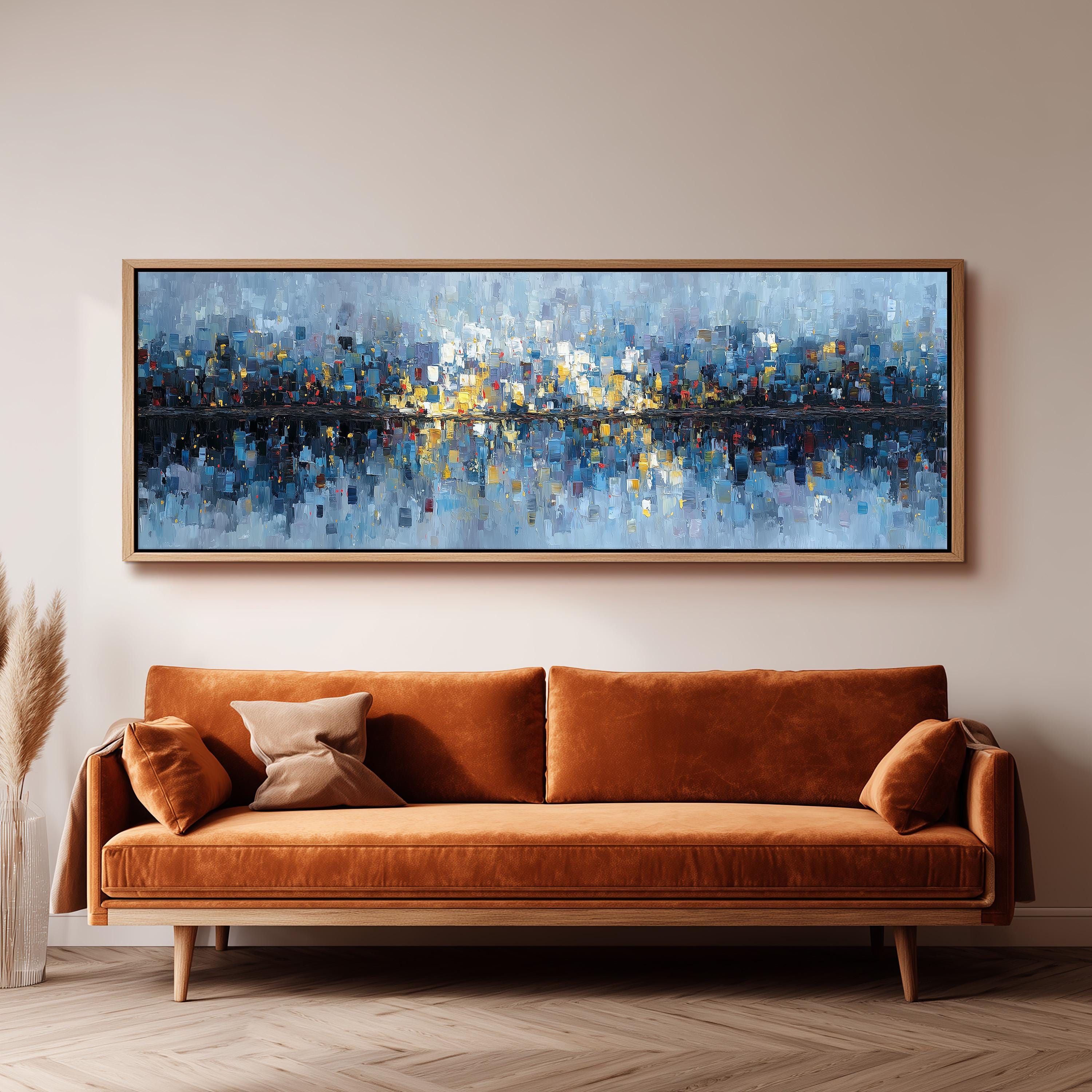 a large, rectangular painting hanging on a wall above a brown sofa.