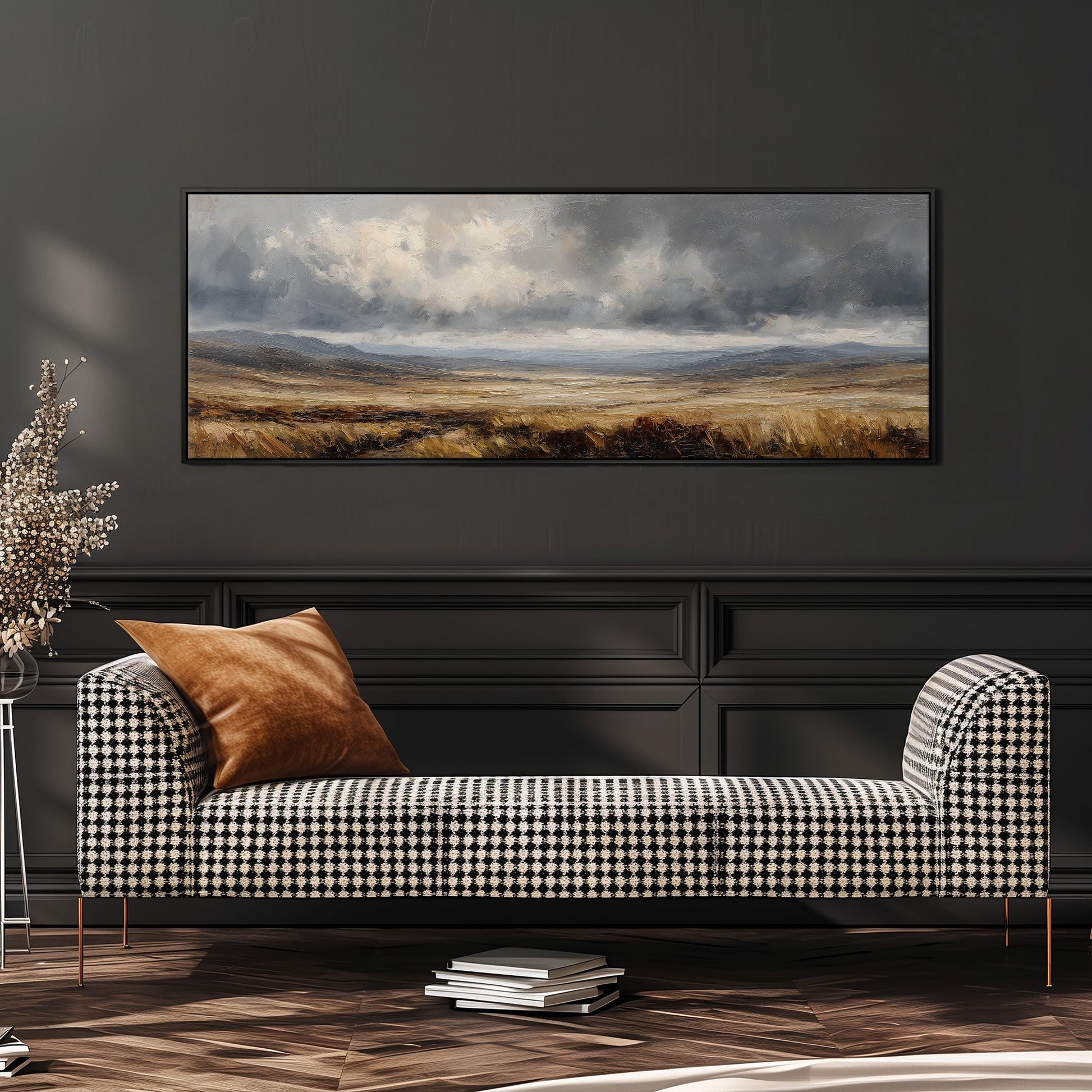 a large landscape painting hanging on a dark wall above a black and white checkered sofa with a brown throw pillow.