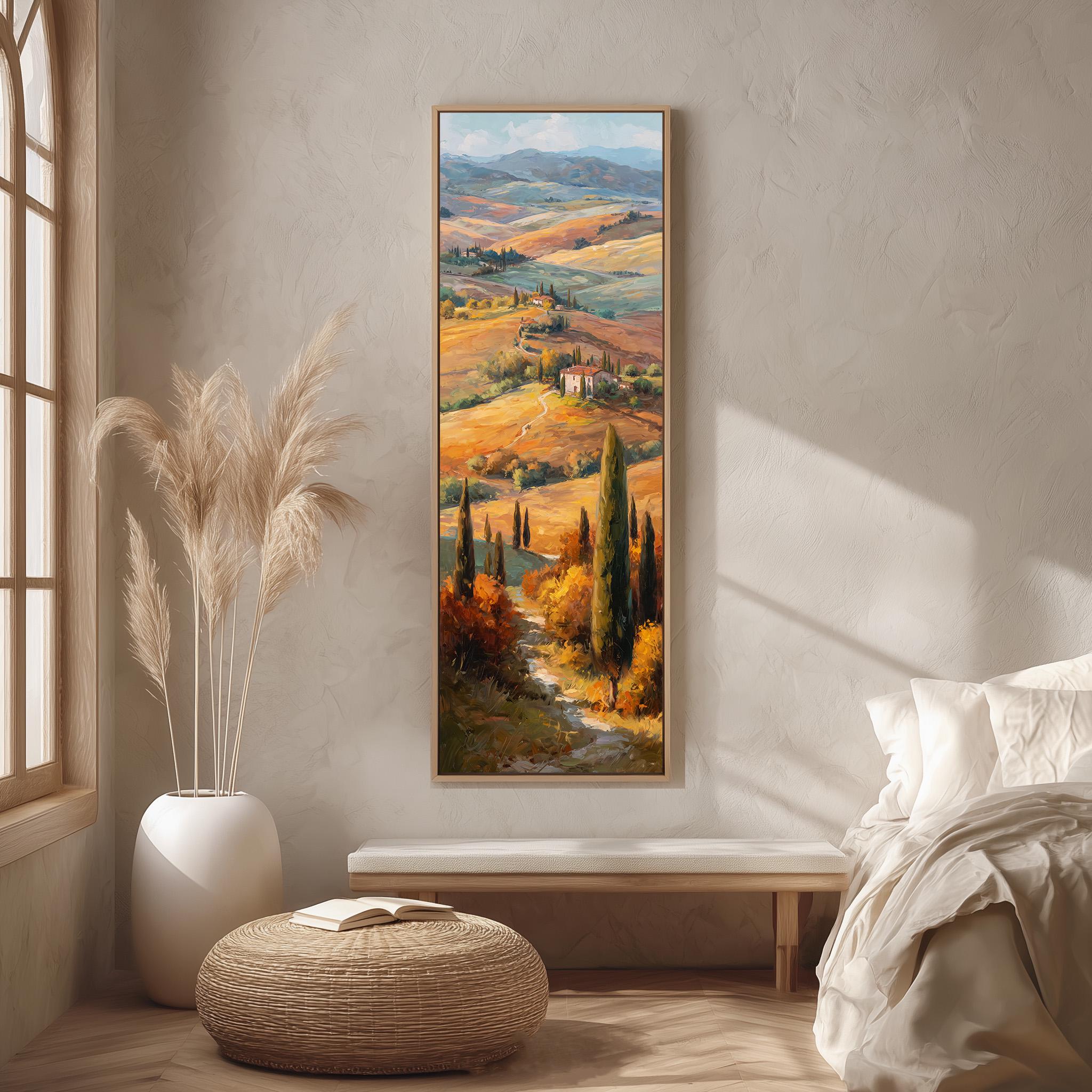 a large painting of a countryside landscape hanging on a wall in a room with a bed, a potted plant, and a woven ottoman.