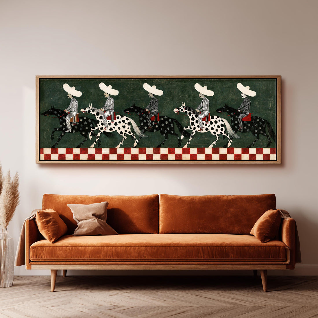 Riders in sombreros on spotted horses long horizontal canvas print above a sofa in a living room