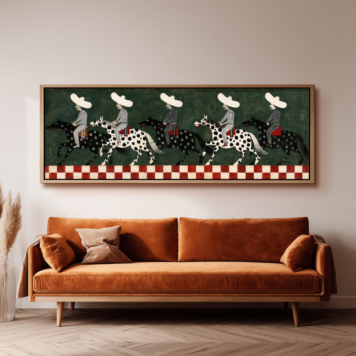Riders in sombreros on spotted horses long horizontal canvas print above a sofa in a living room