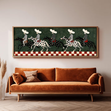 Riders in sombreros on spotted horses long horizontal canvas print above a sofa in a living room