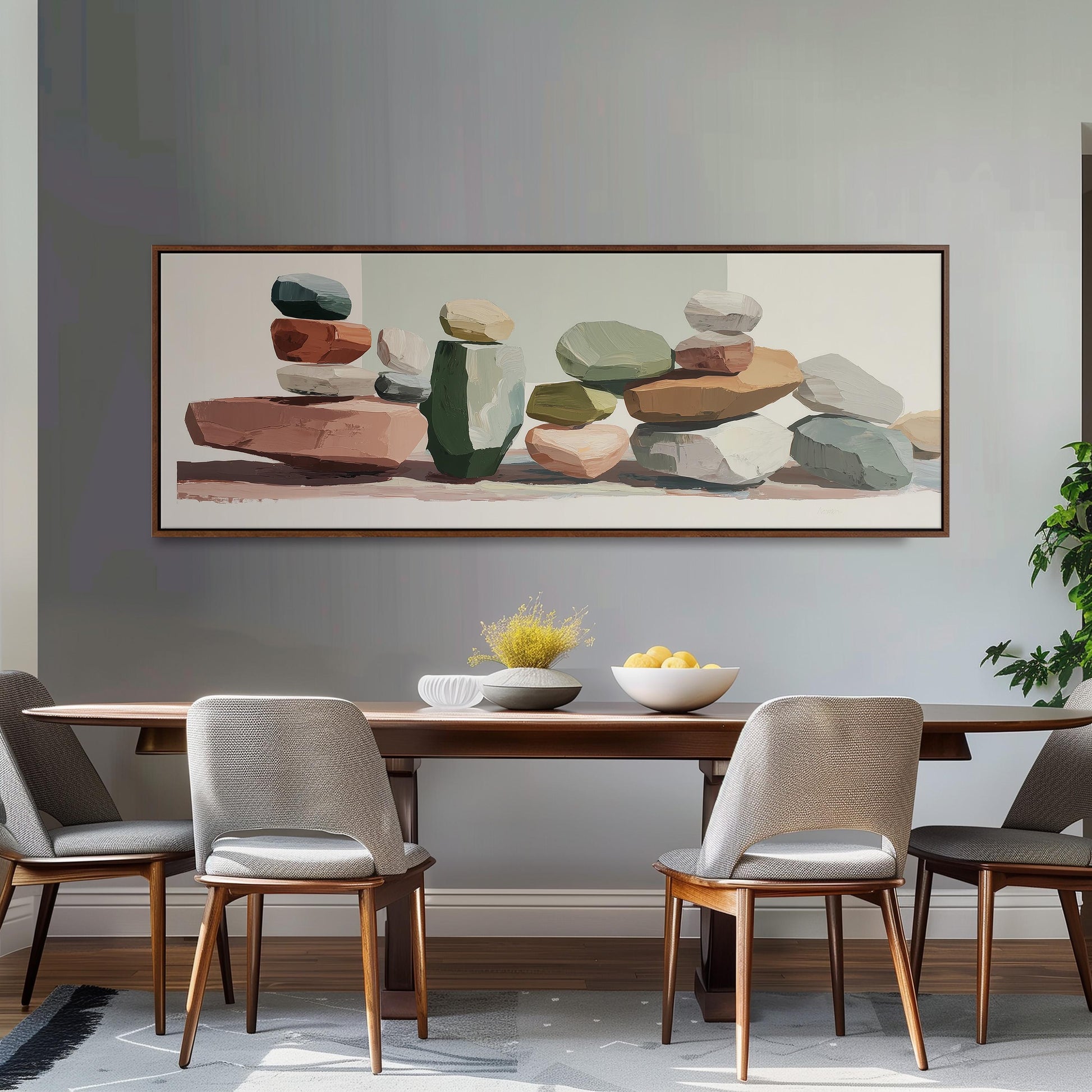 a dining room with a wooden table and four chairs. Above the table, there is a large painting depicting a collection of colorful rocks and stones. The painting is framed and hangs on the wall above the table.