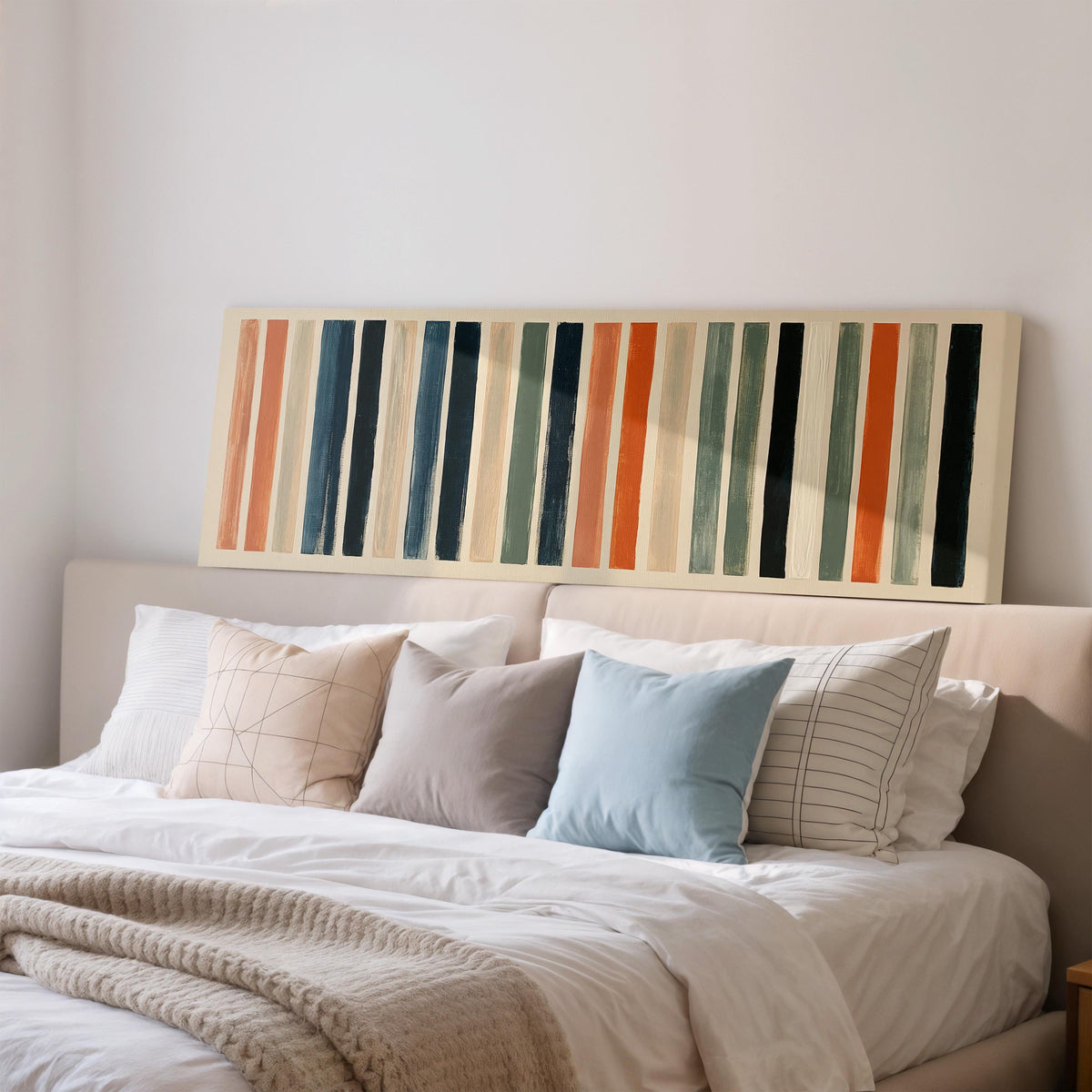 Bold peach, sage and navy stripes wide panoramic canvas print above a bed in a bedroom