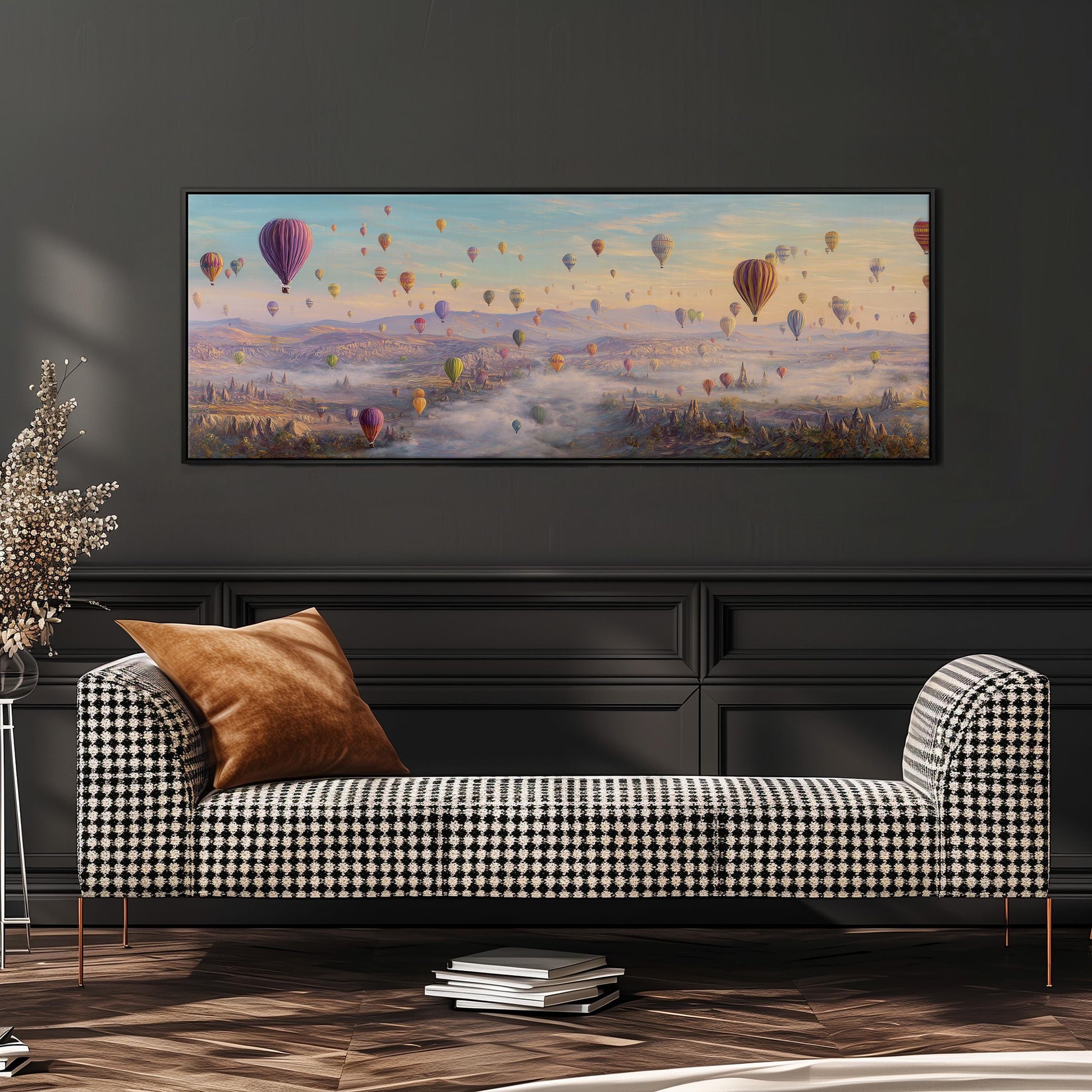 a large painting of hot air balloons floating in the sky above a city, with a checkered sofa in the foreground.