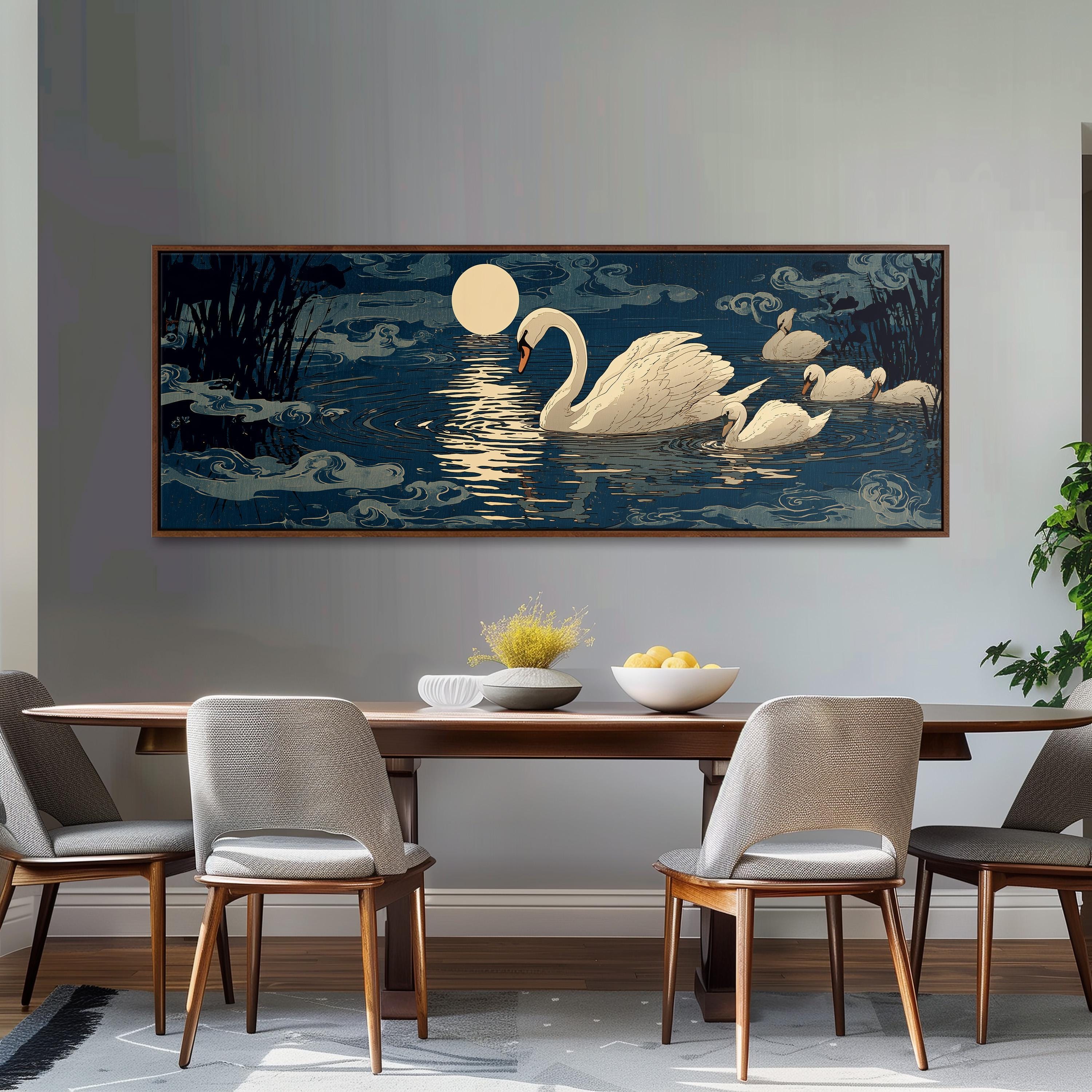 a large painting of a swan swimming on a lake at night, with a full moon and clouds in the background. The painting is hung on a wall above a wooden dining table with four chairs around it. The table is set with a bowl of fruit and a vase of flowers, creating a cozy and inviting atmosphere.