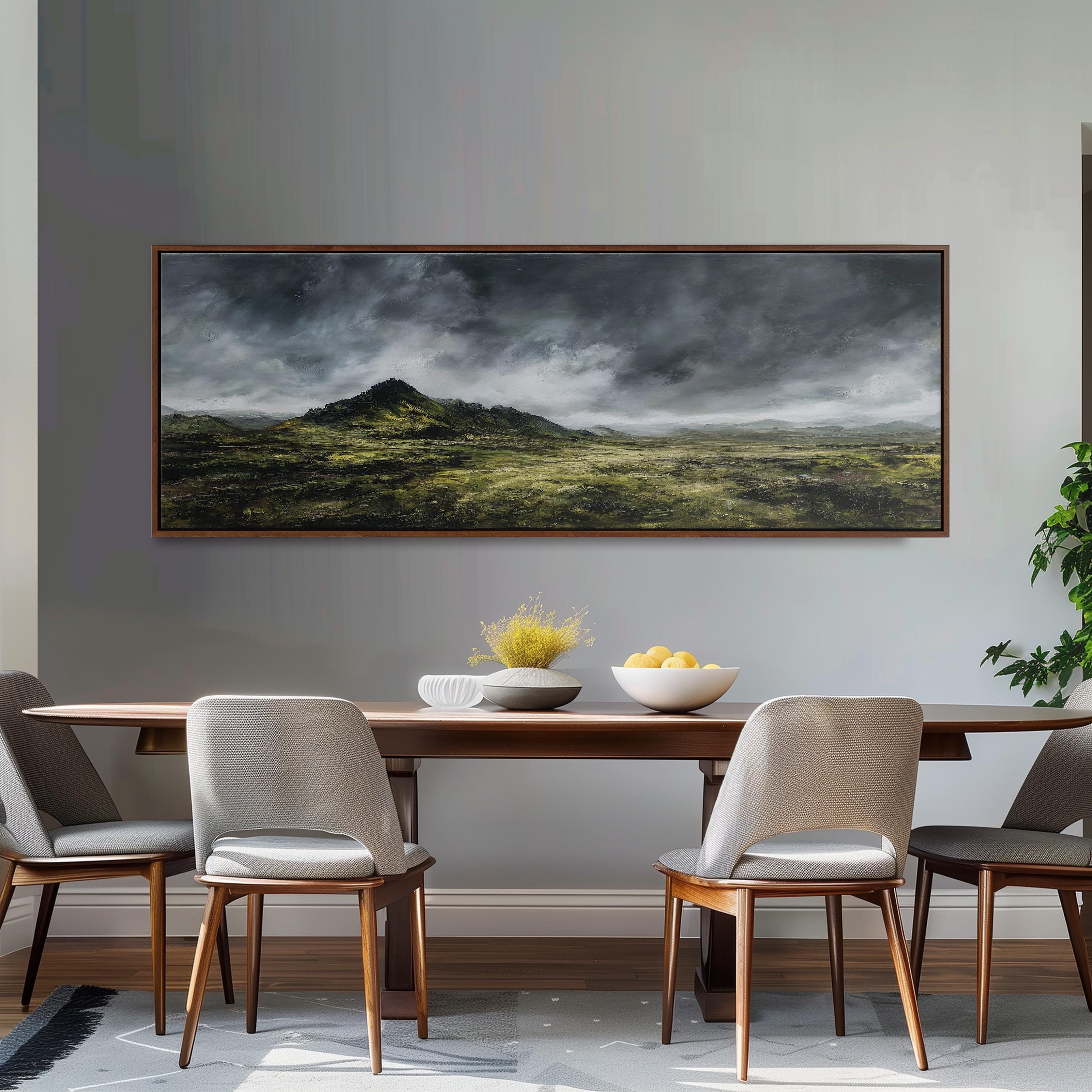 a dining room with a large painting of a landscape hanging on the wall above a wooden dining table with four chairs. The painting depicts a cloudy, mountainous landscape with a sense of tranquility and natural beauty.