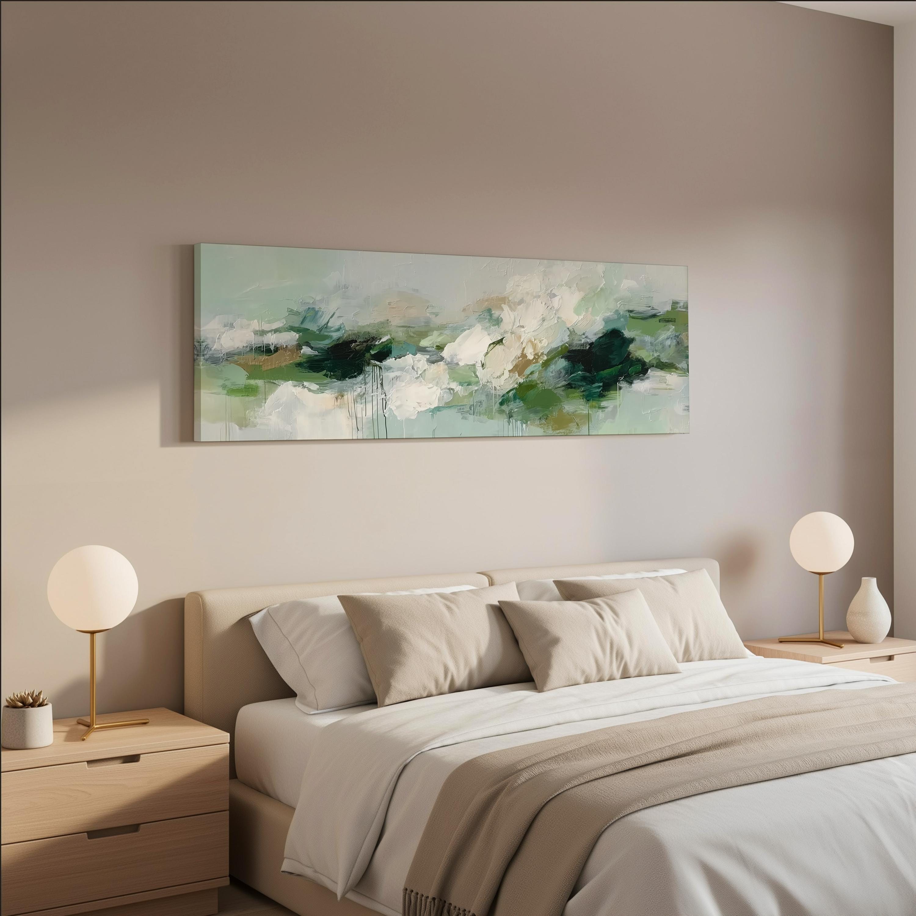 a serene and modern bedroom with a large bed adorned with white and beige bedding, flanked by two white lamps on nightstands. Above the bed hangs a large abstract painting in shades of green and white, creating a calming and tranquil atmosphere in the room.