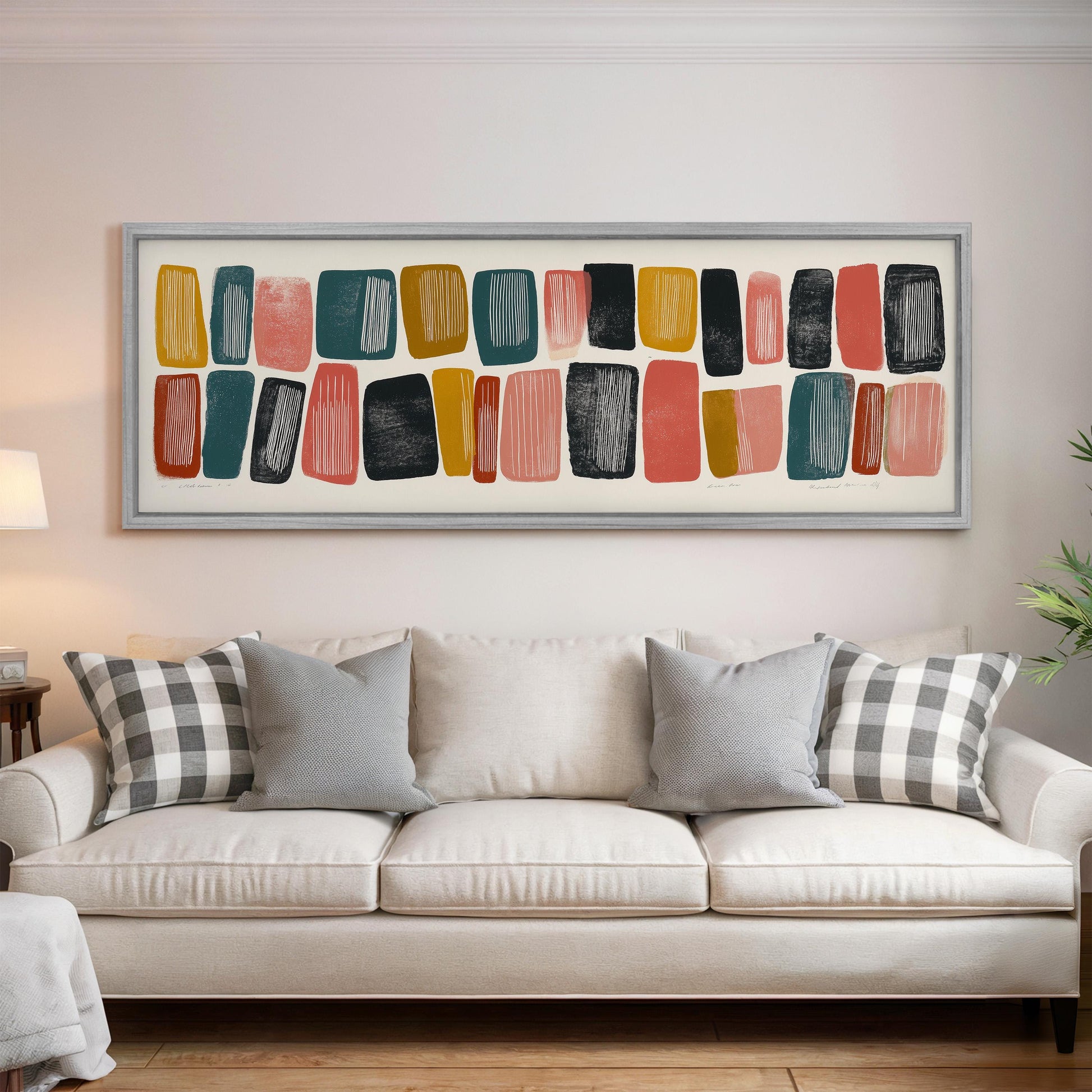 a large abstract painting hanging on a wall above a white couch with gray and black plaid throw pillows.