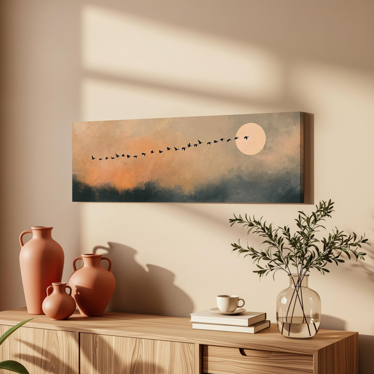 Migrating birds passing a moon at peach dusk long horizontal canvas print above a wooden sideboard