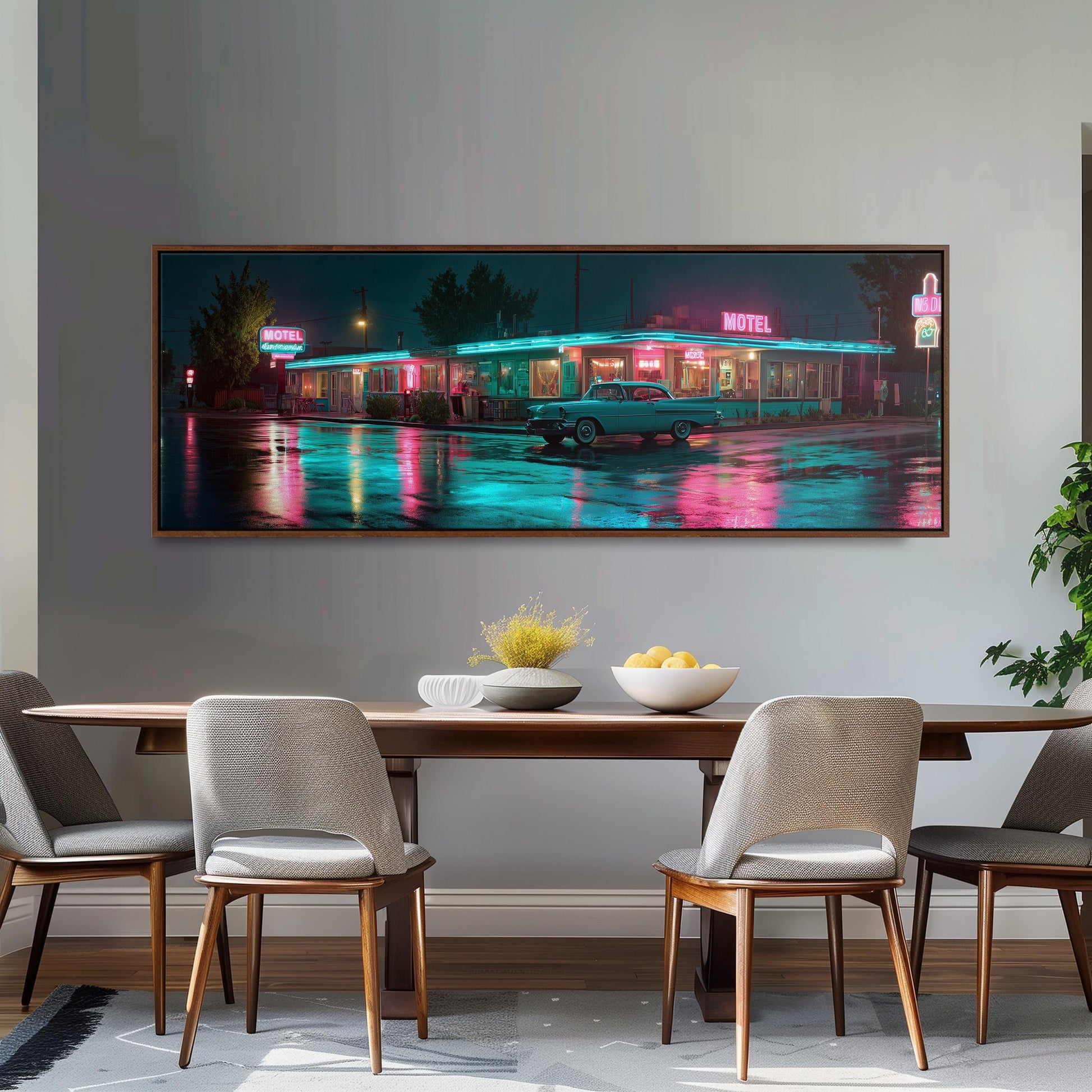 a large framed painting of a motel at night, with neon lights illuminating the scene. The painting is displayed on a wall above a wooden dining table with four chairs.