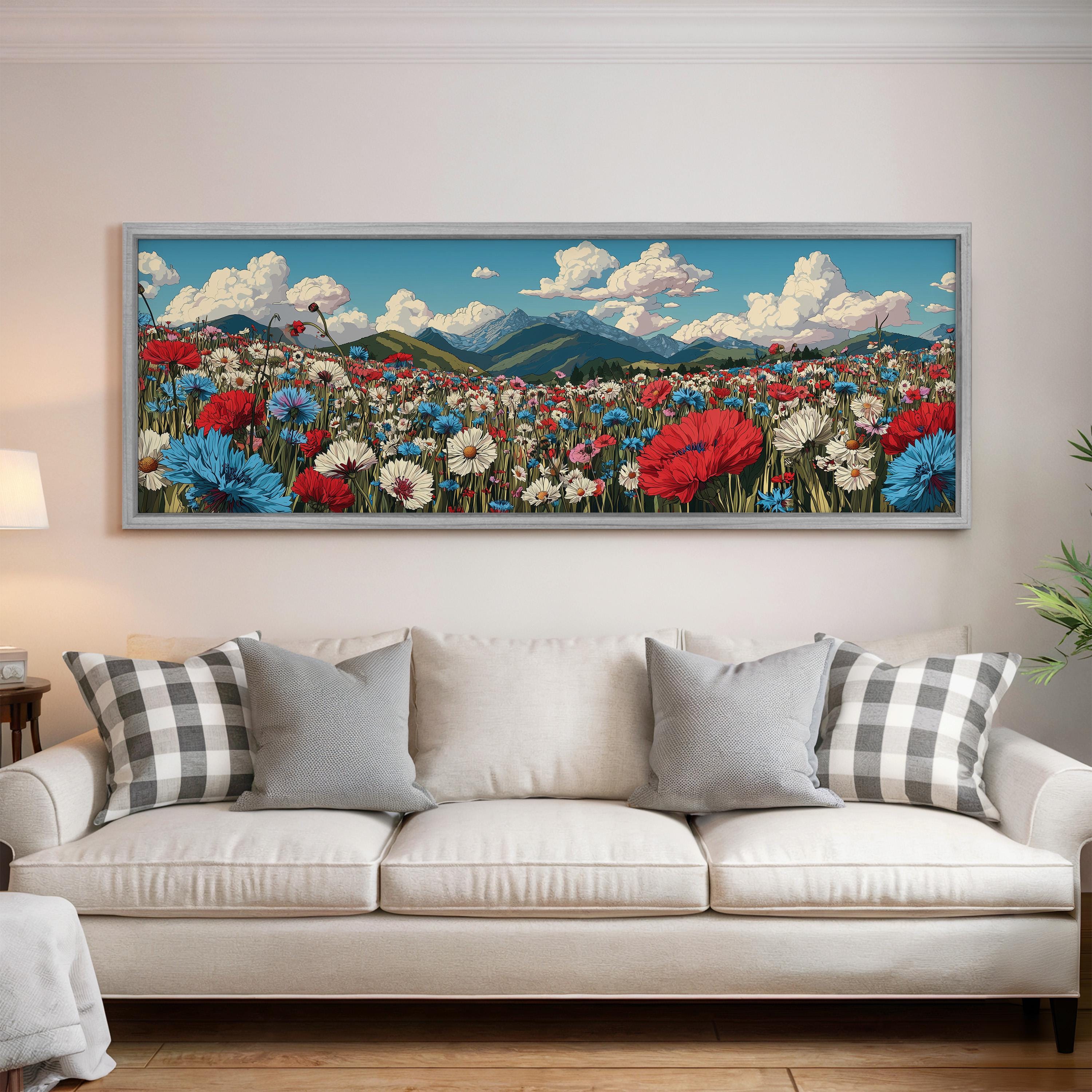a large, colorful painting of a flower field hanging on a wall above a white couch with gray and white plaid throw pillows.