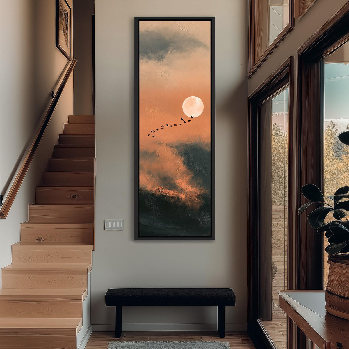 Birds flying past a rising moon in an orange sky tall narrow canvas print beside a staircase in an entryway
