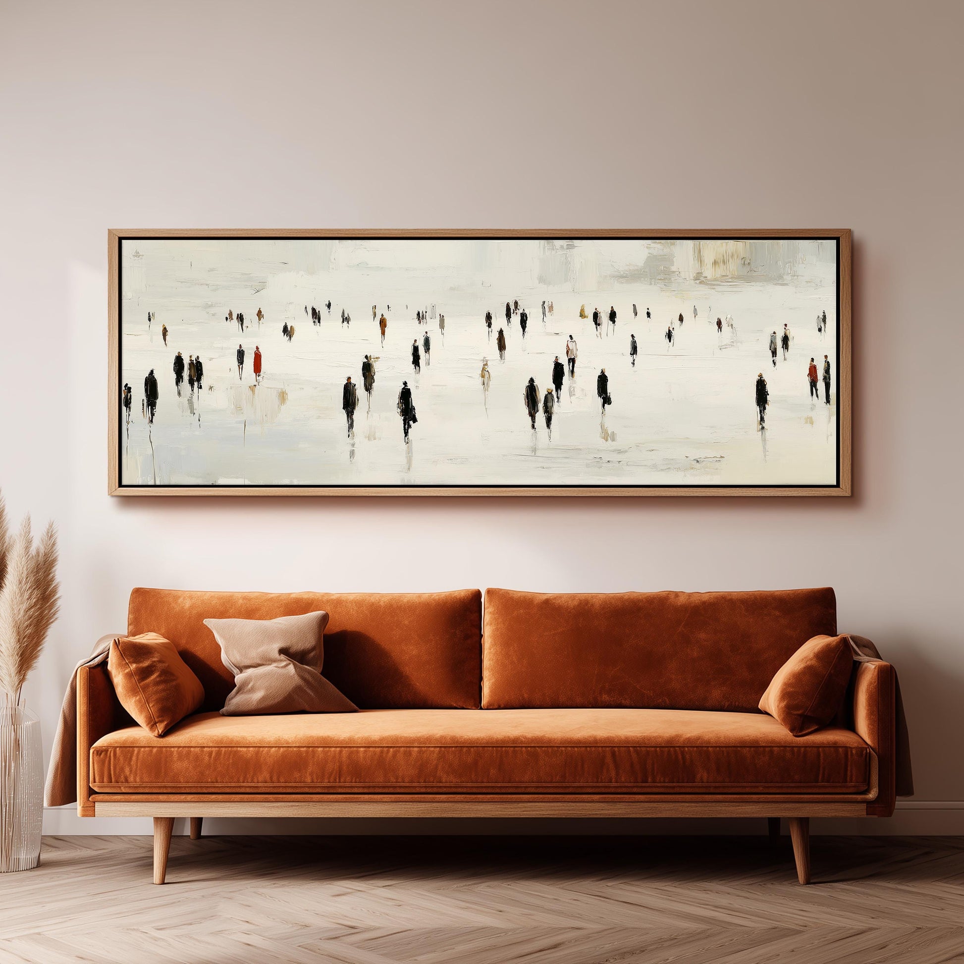 a large painting of a group of people walking on a snowy street, hanging on a wall above a brown sofa.